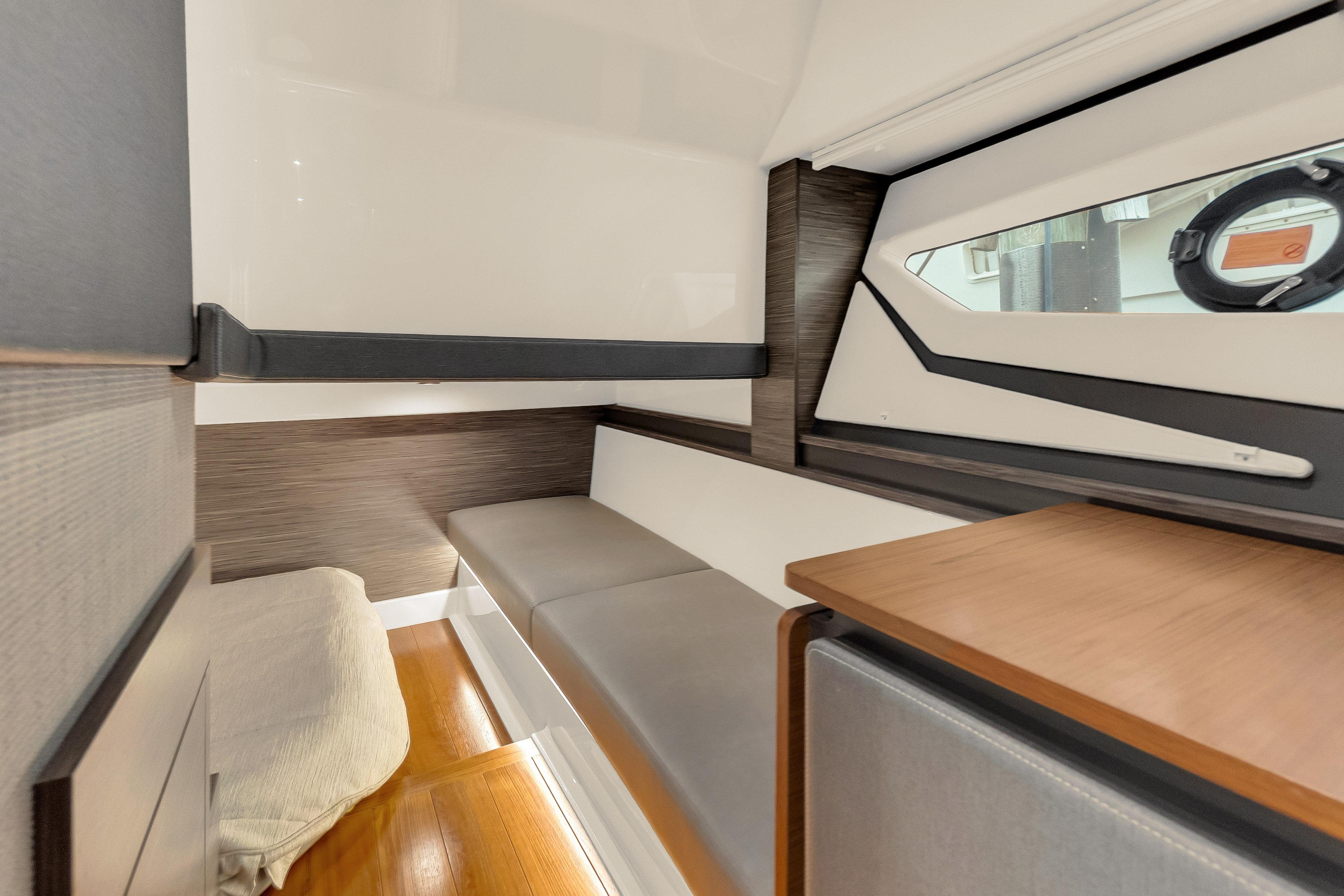2021 Tiara Sport 43 LE cabin interior with modern seating and window view.