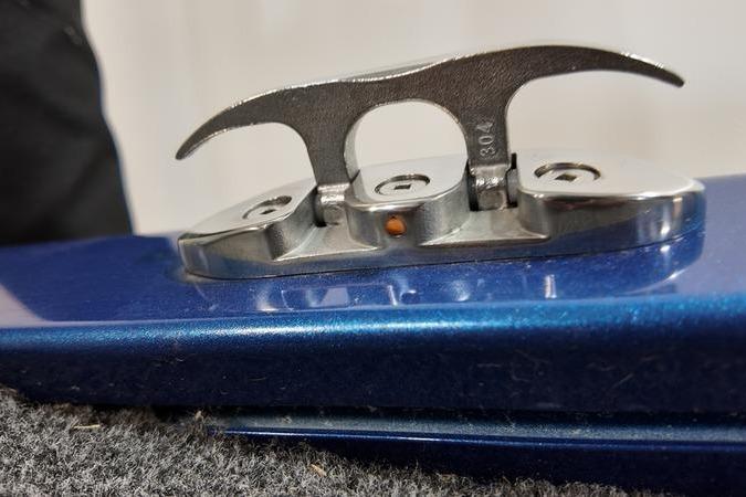 Close-up of a 2024 Lowe Stinger 198 boat cleat on a blue surface.