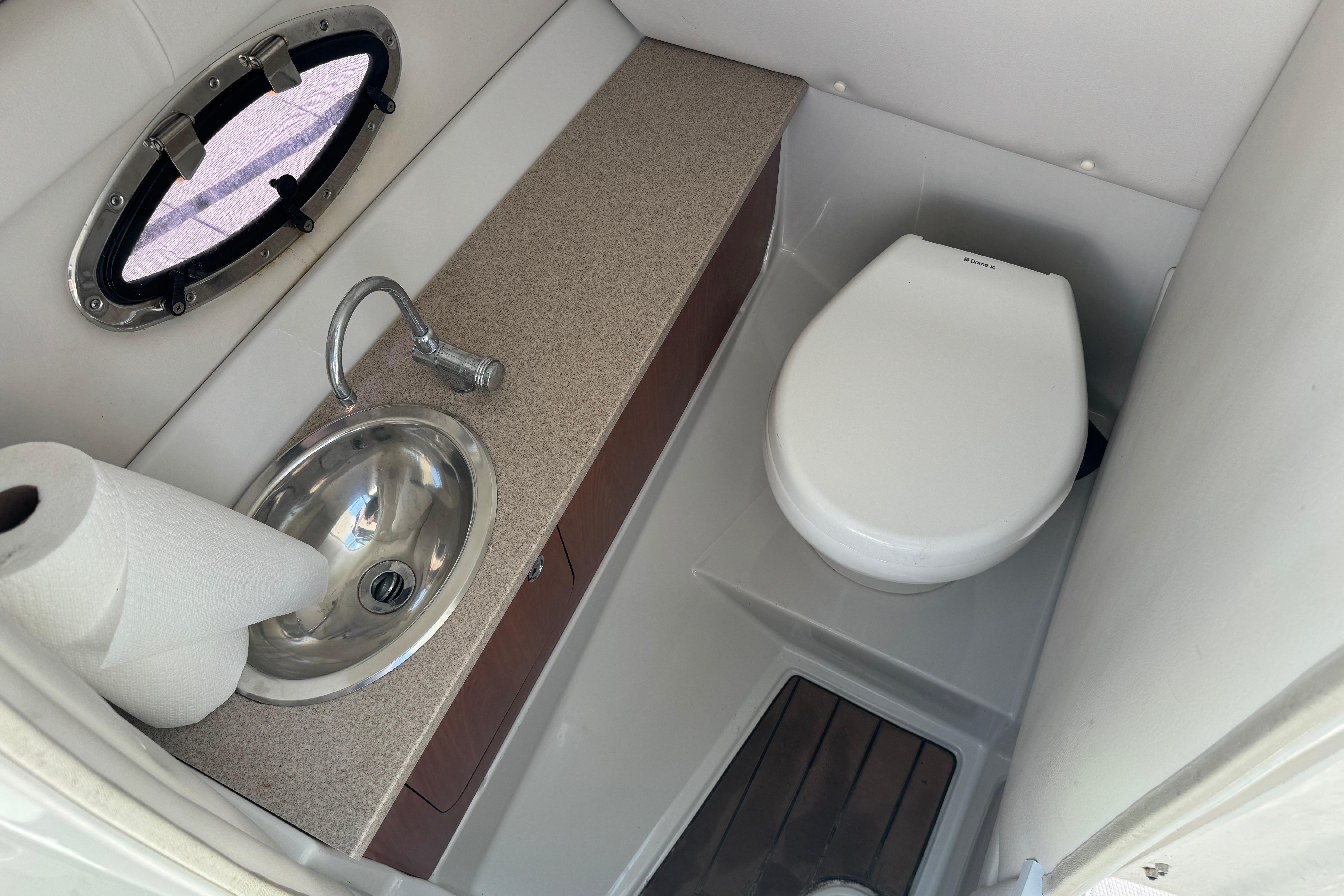 2013 Crownline Eclipse E6 XS boat bathroom with sink and toilet.