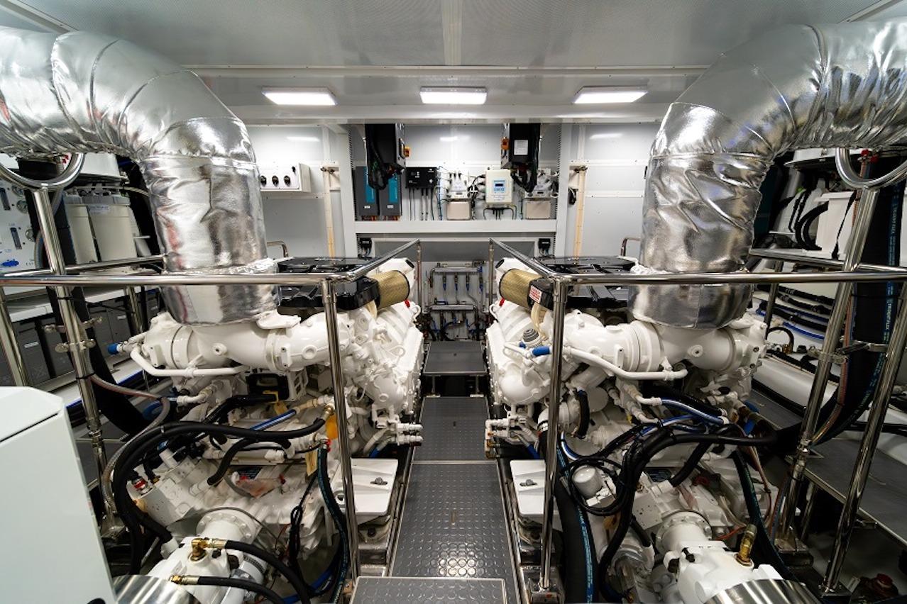 Engine room of 2027 Offshore Yachts 70 CE, featuring dual engines and advanced equipment.