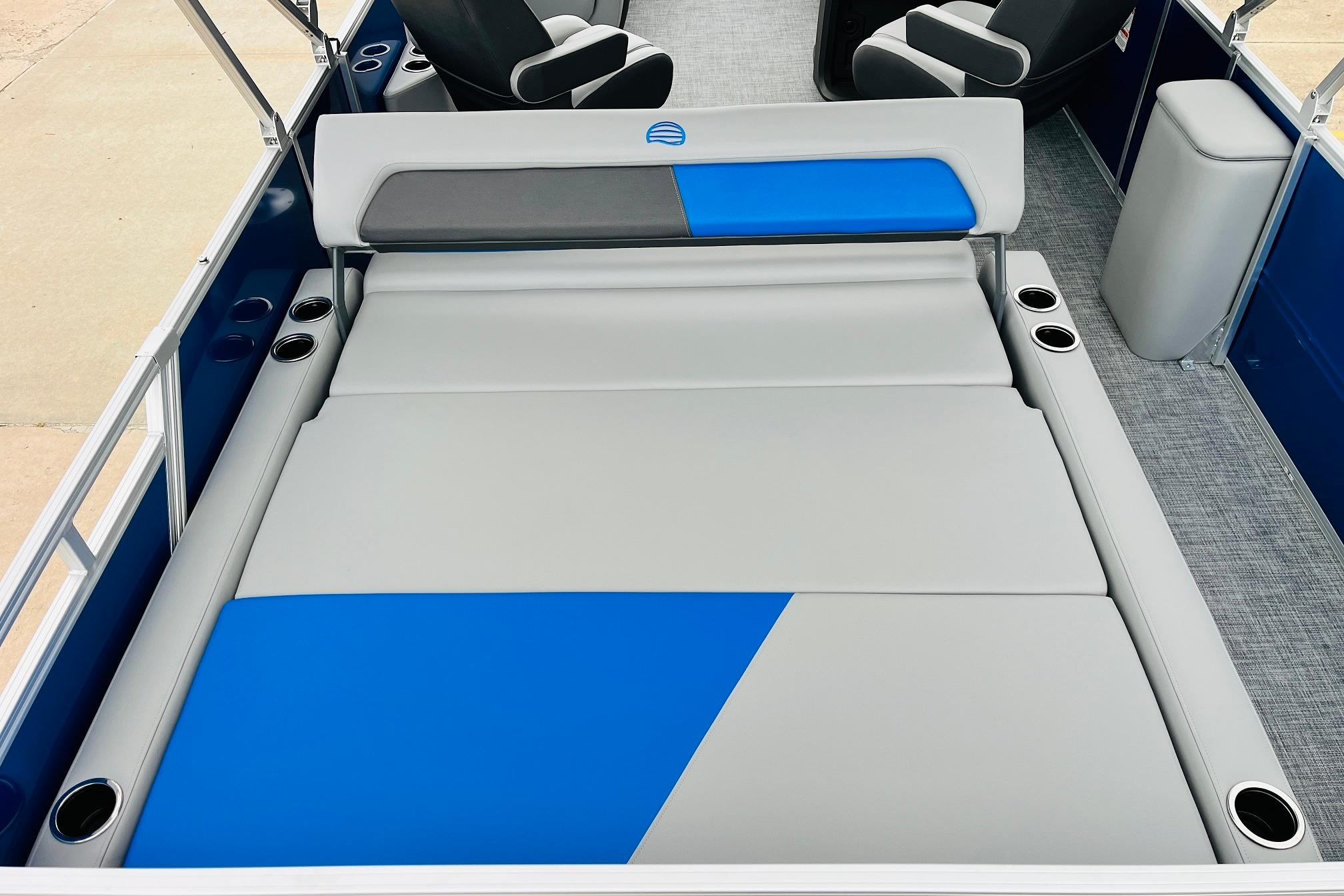 2026 Sun Tracker Party Barge 22 RF DLX interior with blue and gray seating.