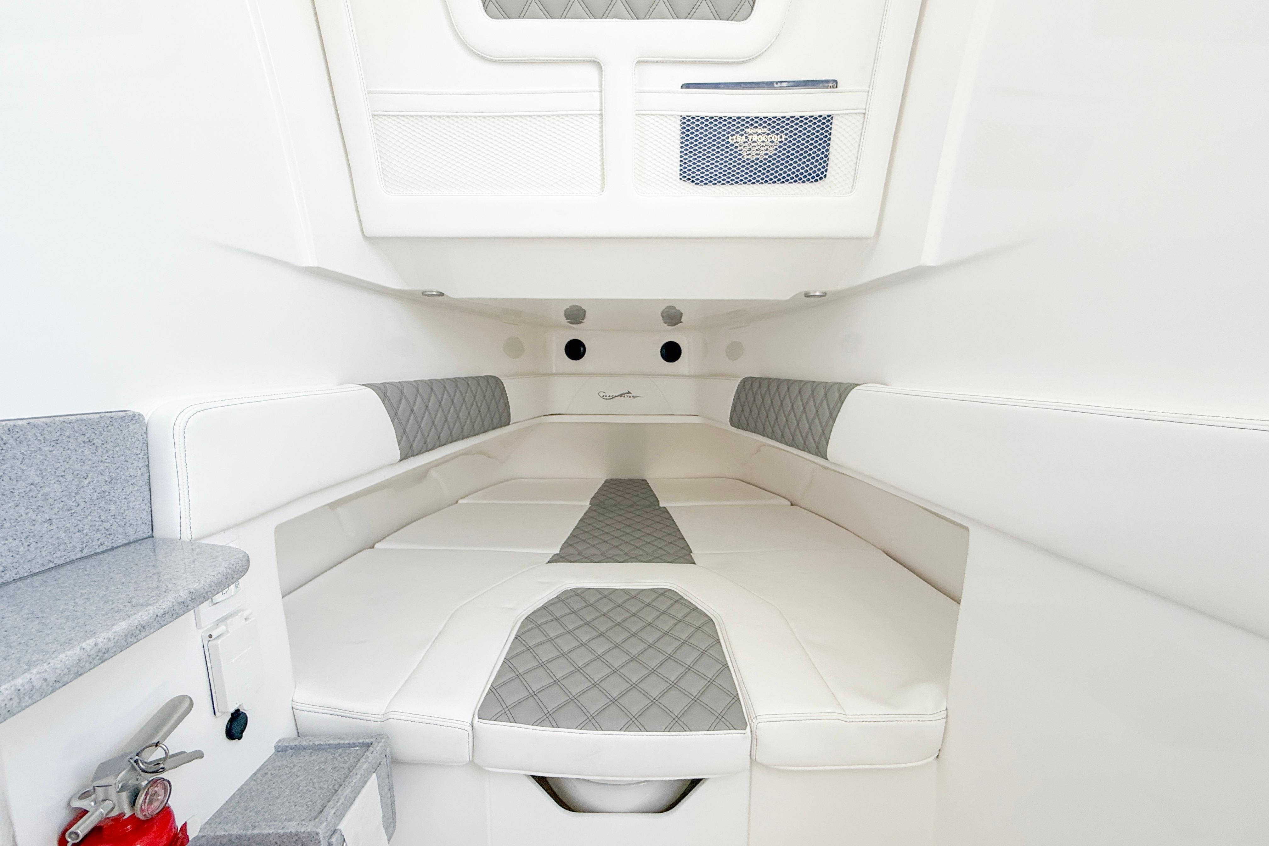 Luxurious interior of 2026 Blackwater 41 Sportfish boat with white and gray seating.
