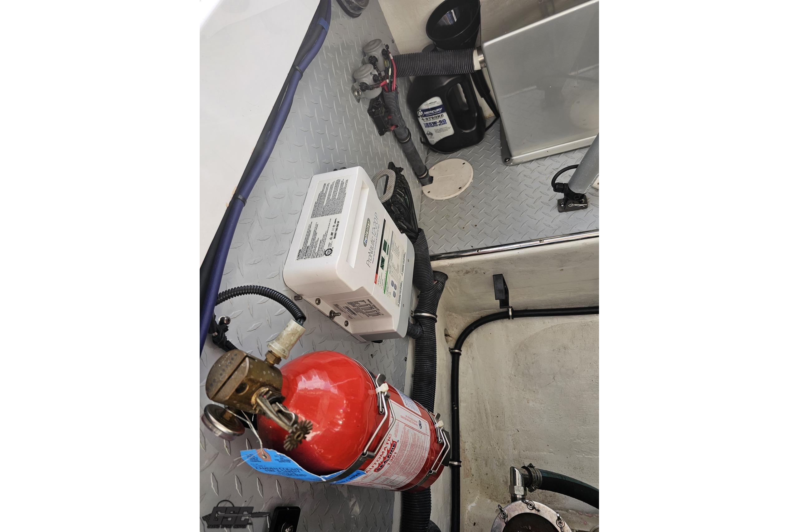Interior of a 2008 Donzi 38 ZR boat showing equipment and fire extinguisher.