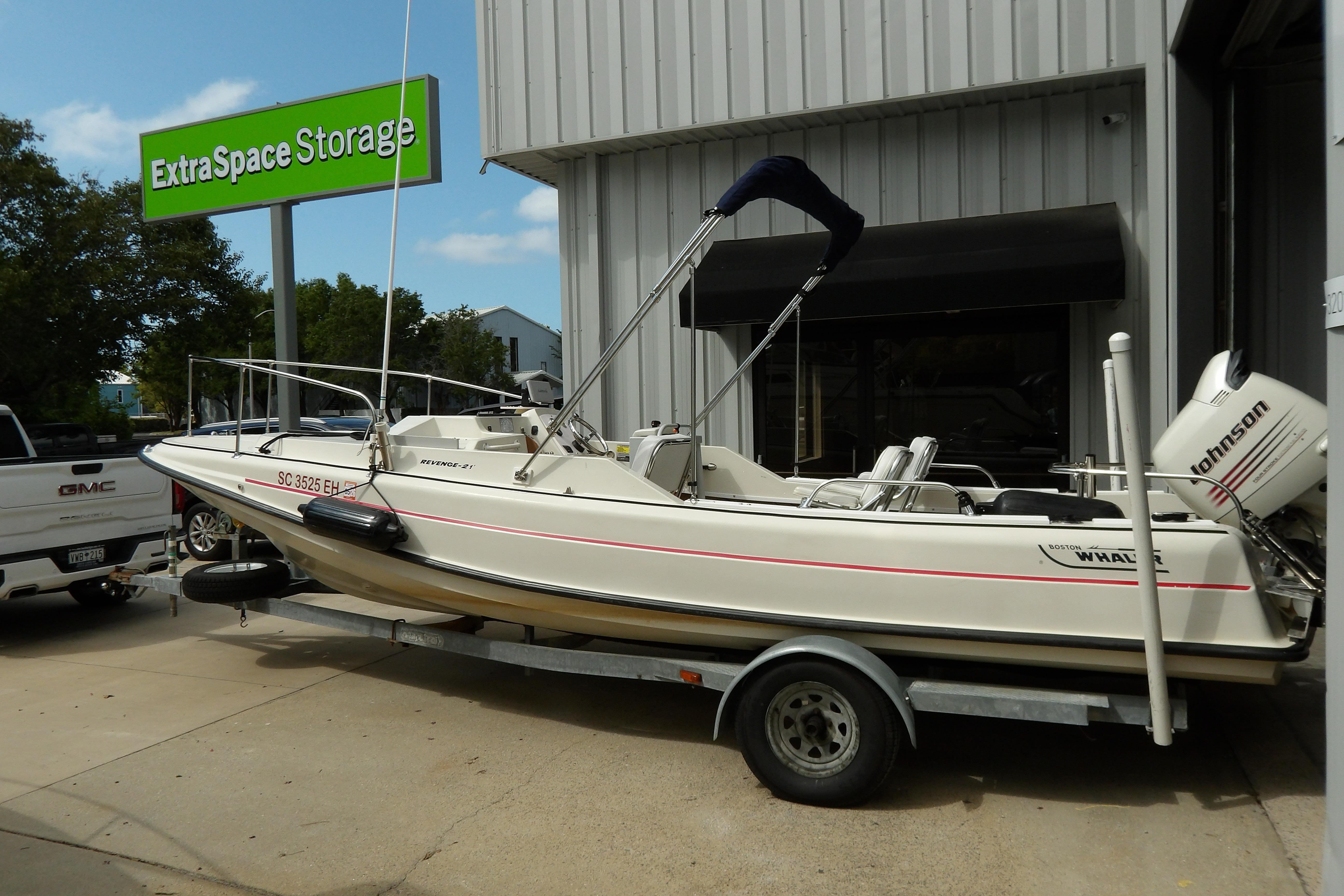 1978 Boston Whaler 21 Revenge boat on trailer near Extra Space Storage facility.