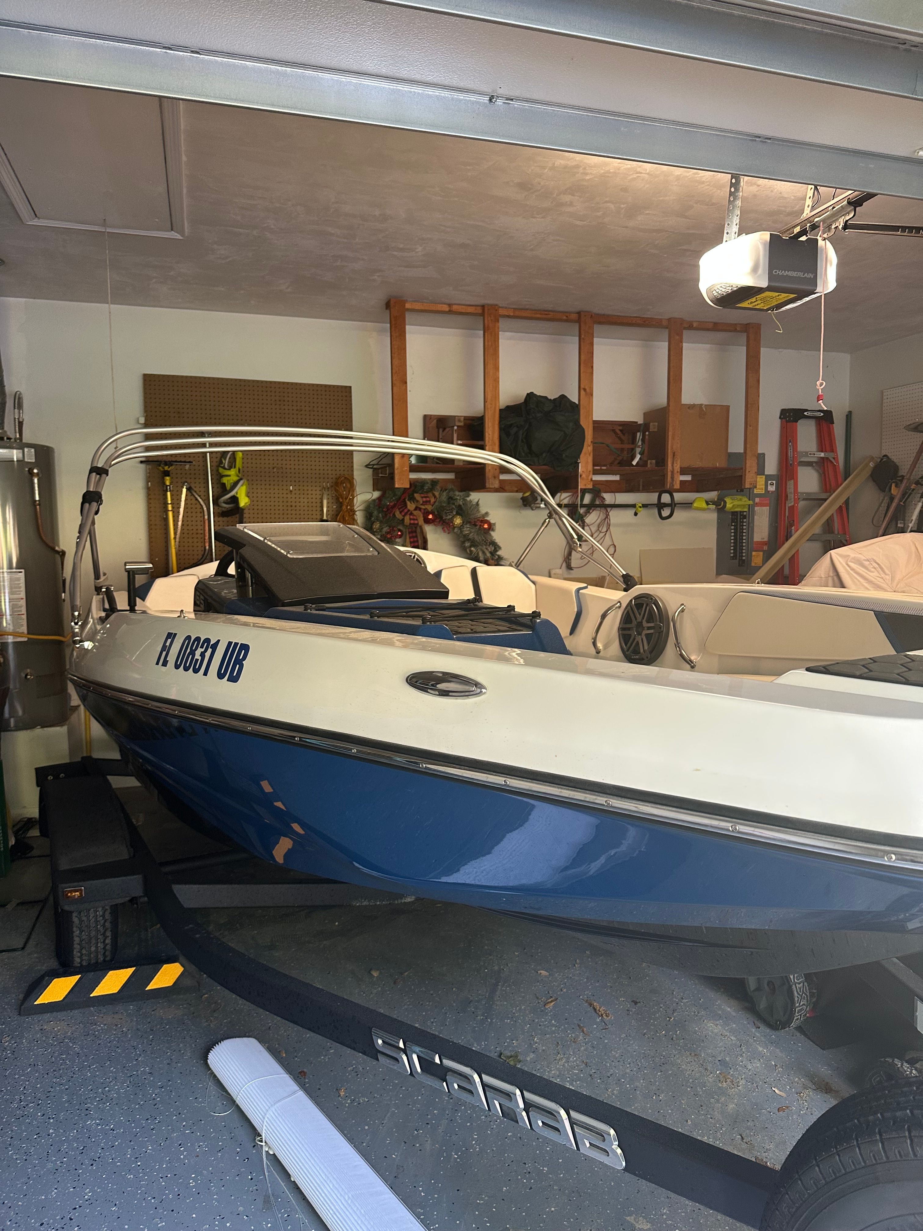 2023 Scarab Identity Jet boat parked in a garage.
