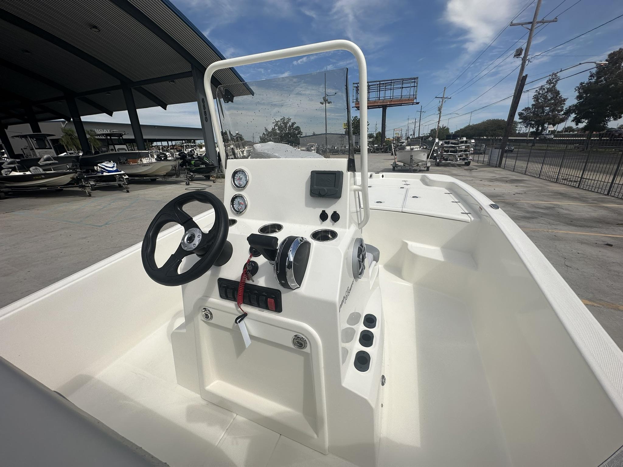 2024 Mako Pro Skiff 19 CC boat interior with steering console and gauges.