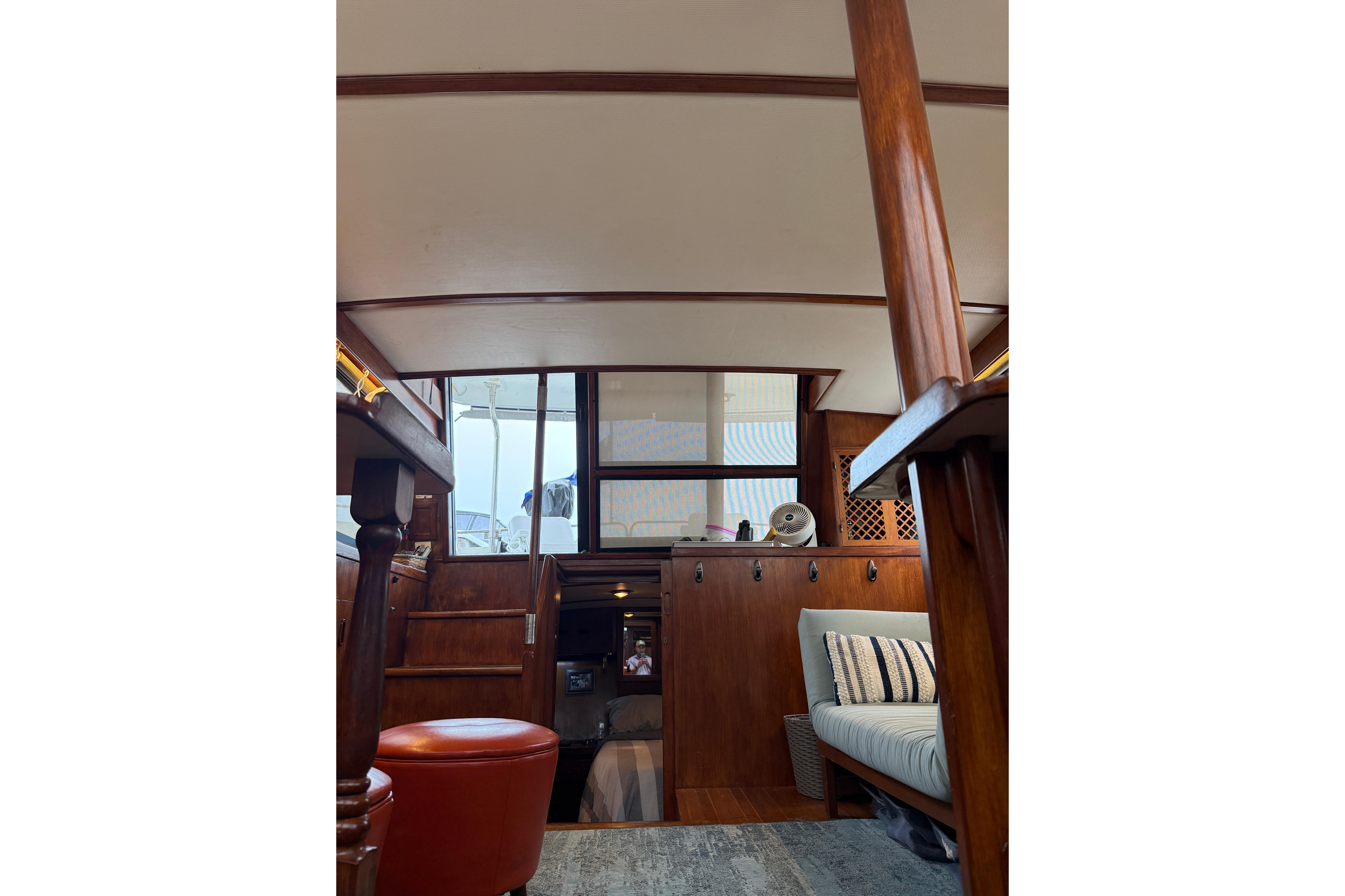 Interior of 1988 President 35 Double Cabin yacht with wooden furnishings and seating area.