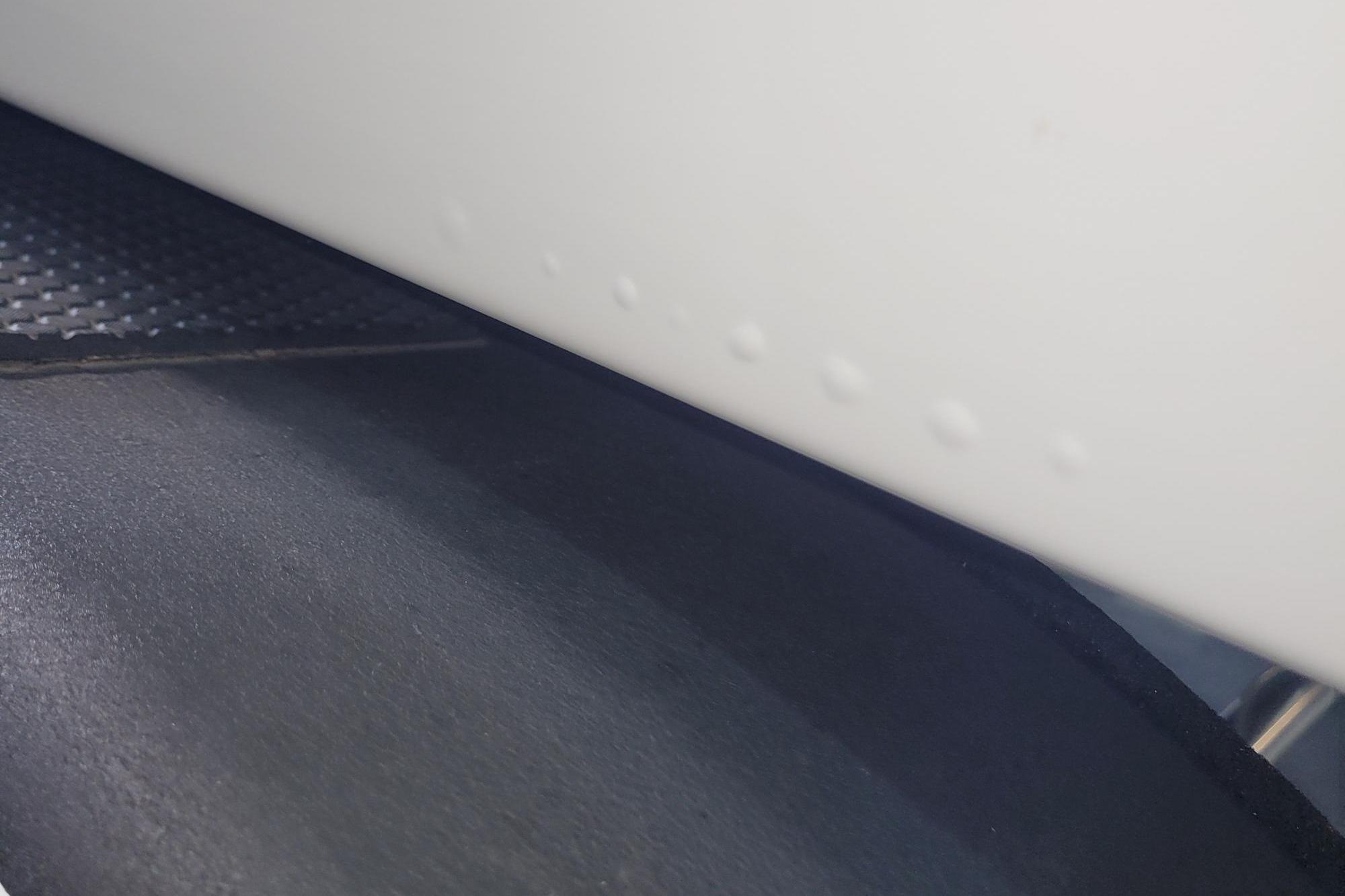 Close-up of 2024 Tahoe 2150 CC boat hull with textured surface detail.