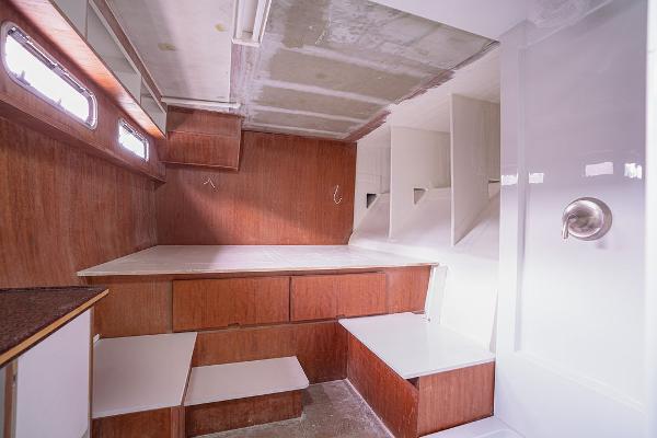 Interior of 2025 Catamaran Bloomfield 86 Motorsailor with wooden cabinetry and modern design.