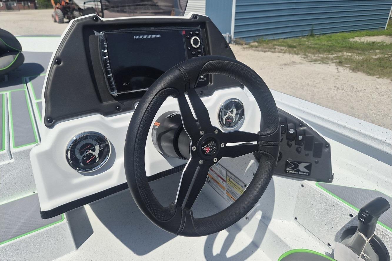 Steering console of 2026 Xpress H18 boat with gauges and navigation system.
