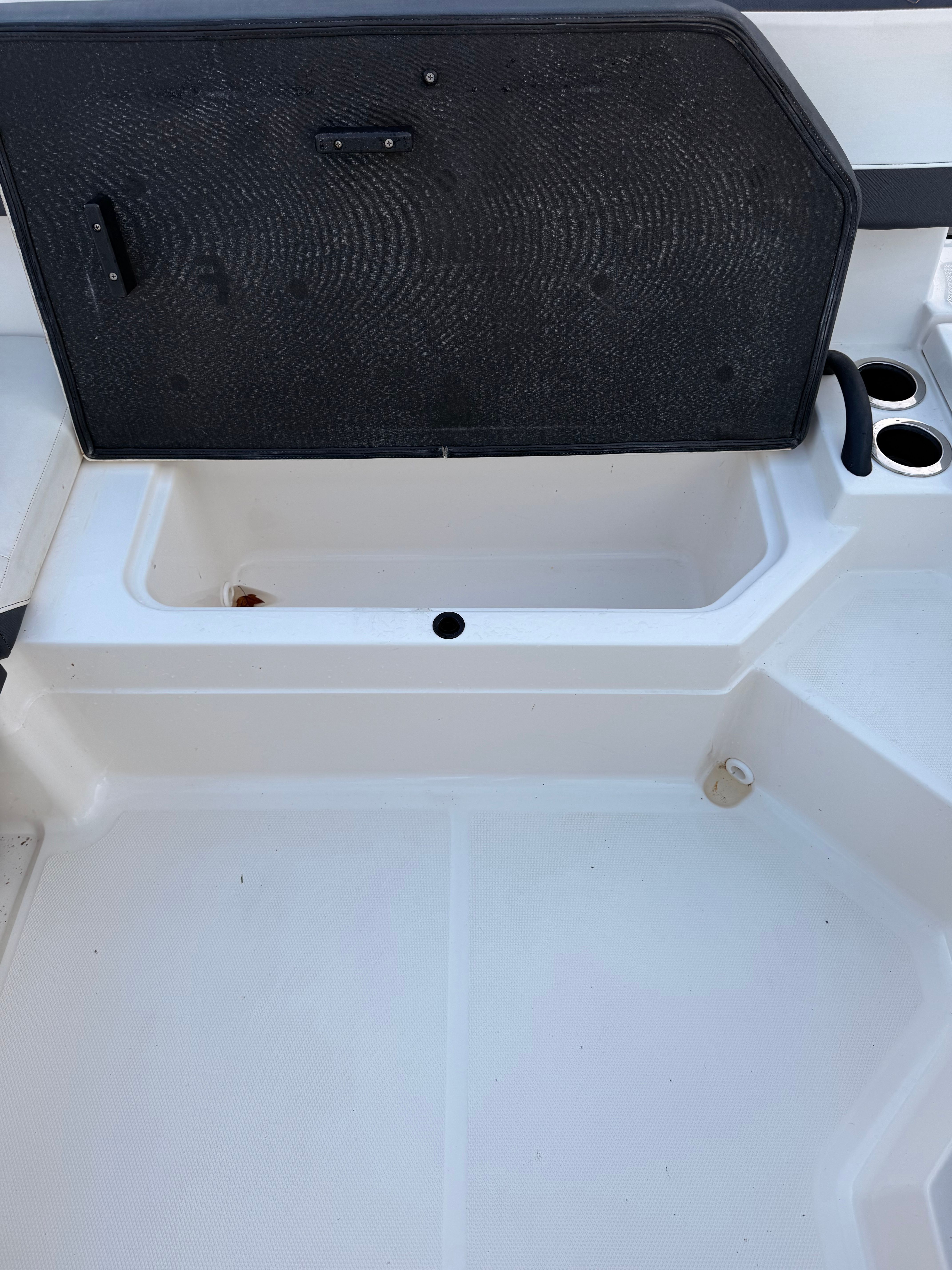 The image shows an open storage compartment on a 2016 Sea Ray SPX 210 Outboard boat.