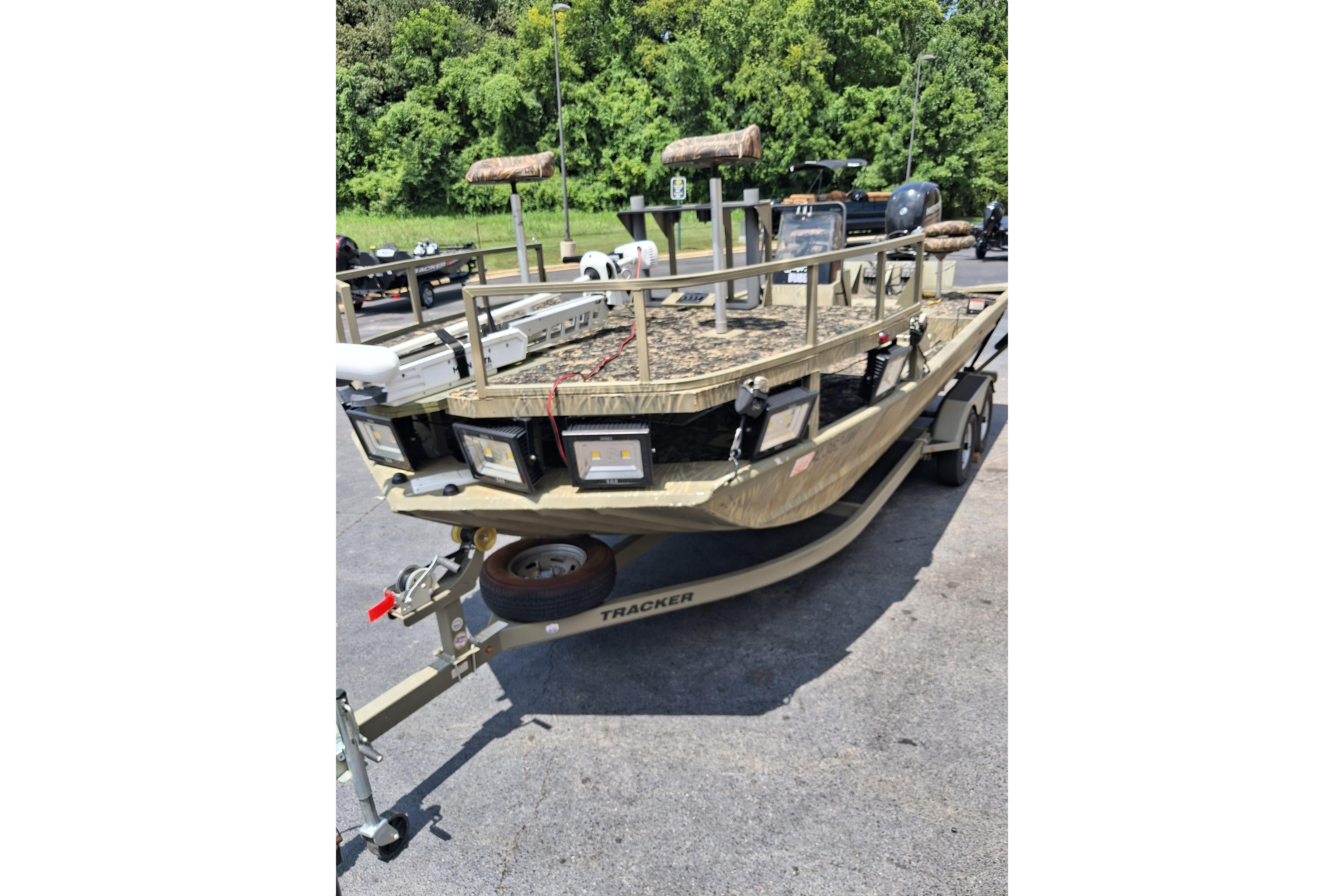 2016 Tracker Grizzly 2072 CC Sportsman boat on trailer, parked outdoors.