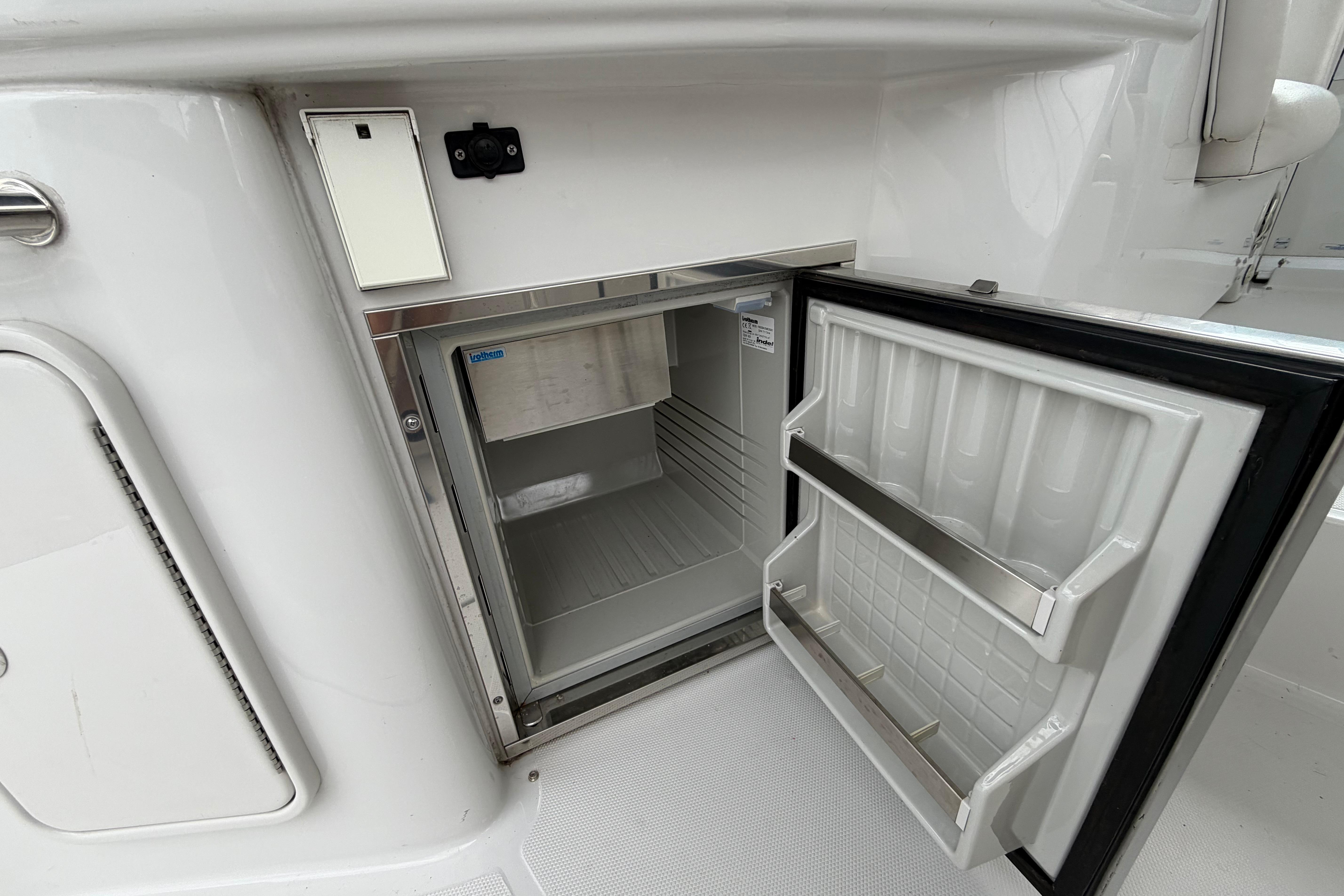 Open refrigerator on 2008 Crownline 340 CR boat, showcasing interior storage space.