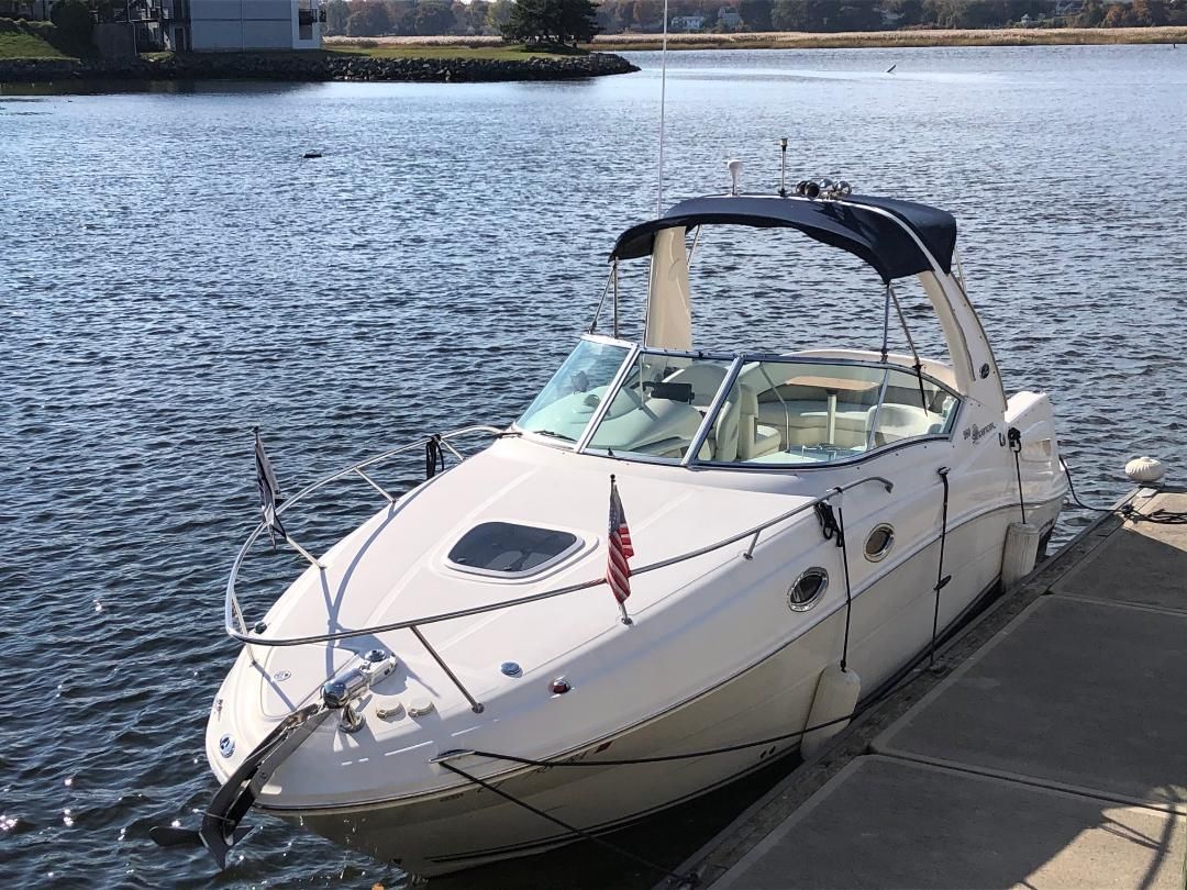 2005 Sea Ray Sundancer 260 docked on the water.