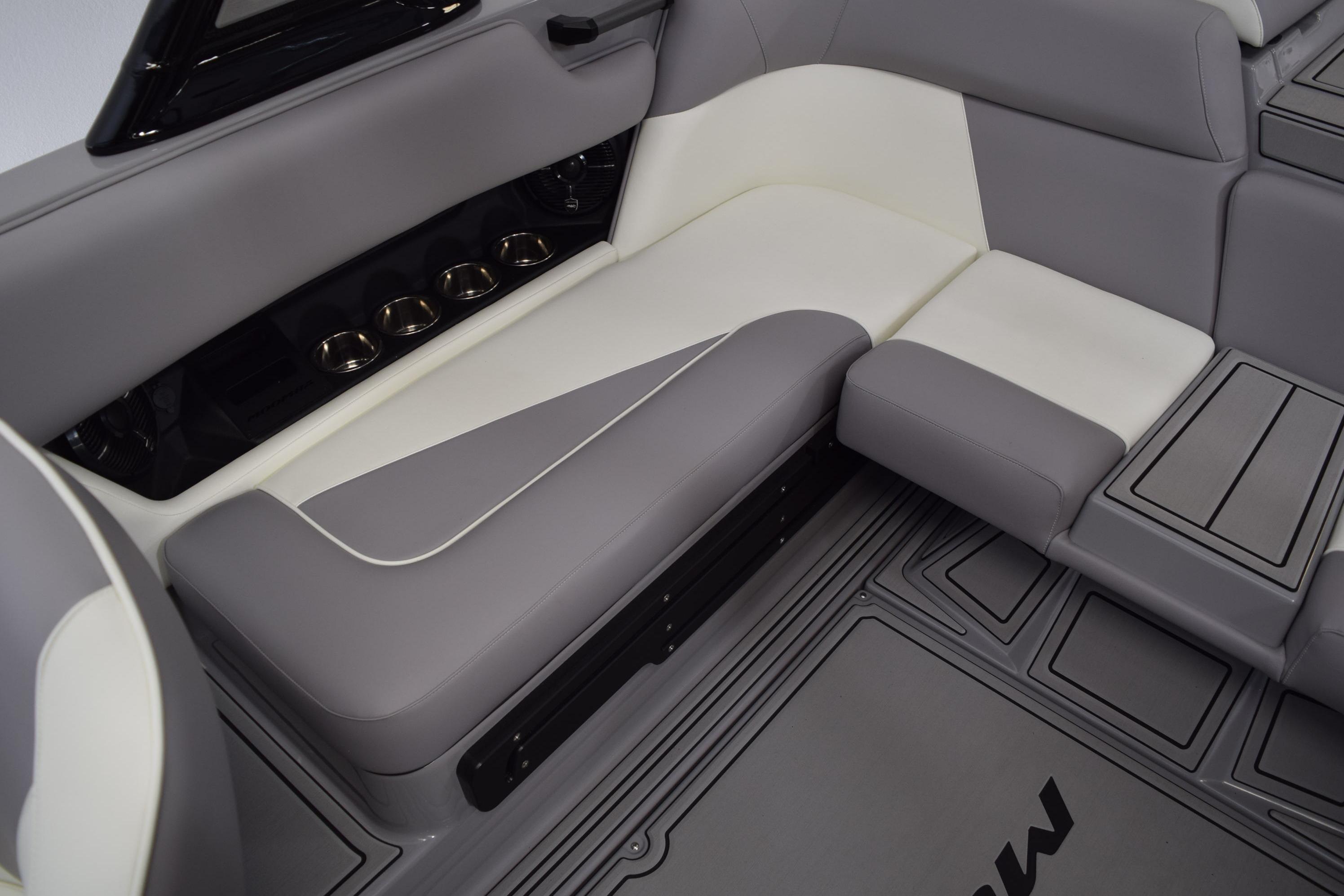 2026 Moomba Craz boat interior with gray and white seating, cup holders, and sleek design.