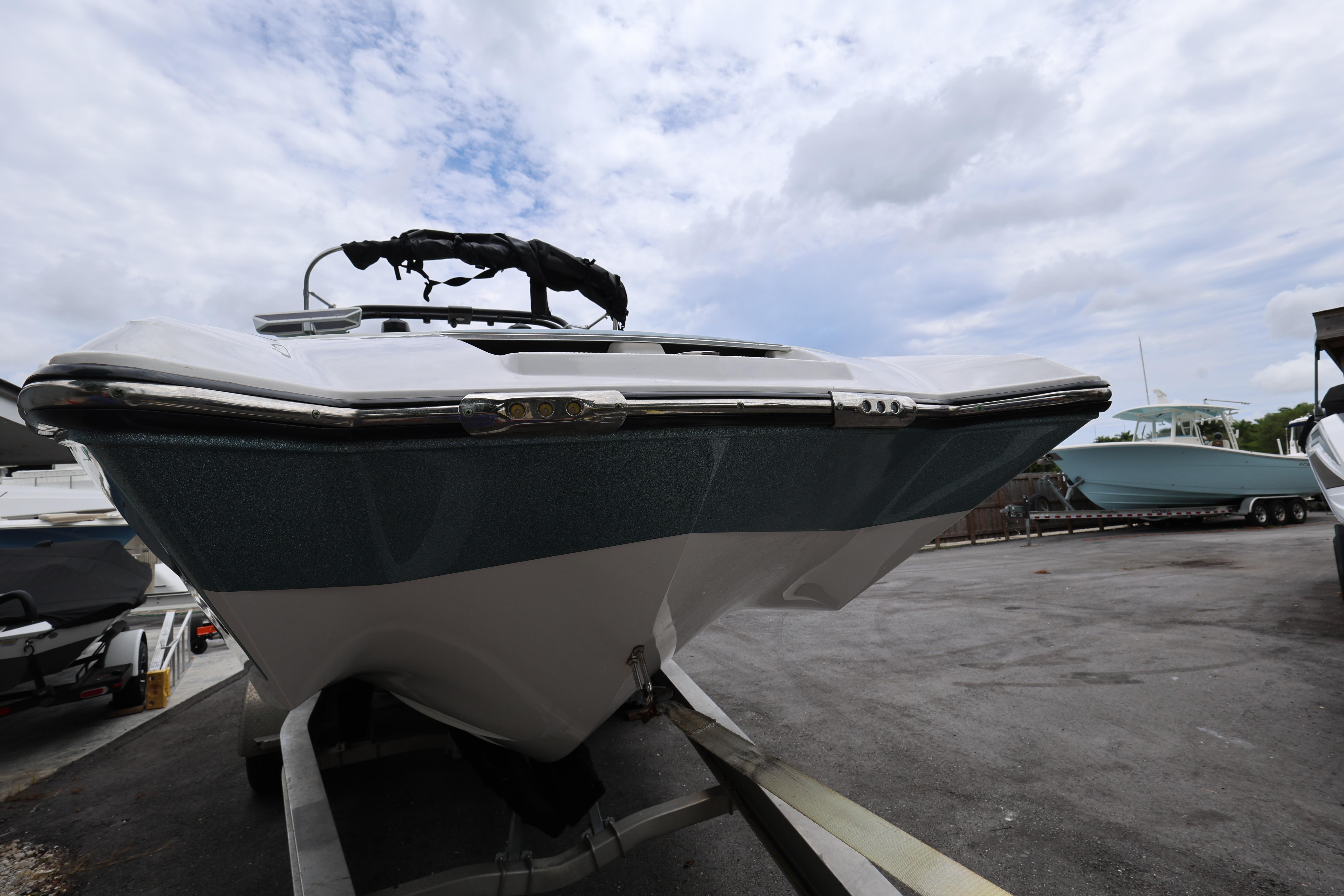 2023 MasterCraft X24 boat on trailer under cloudy sky.