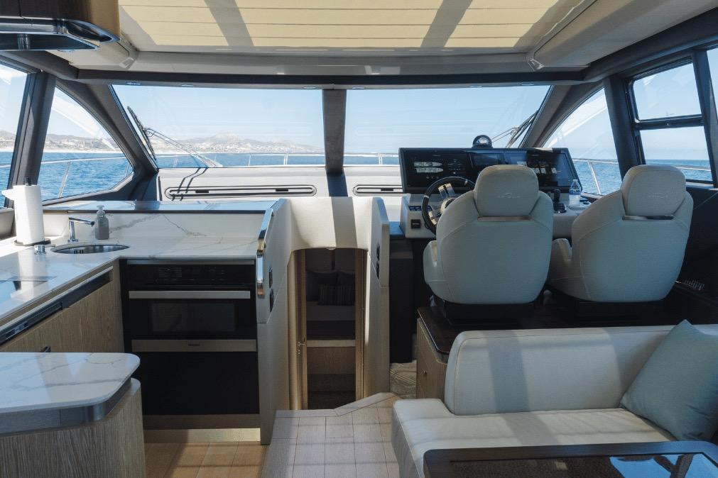 Interior of 2020 Azimut 60 yacht with modern helm, seating, and ocean view.