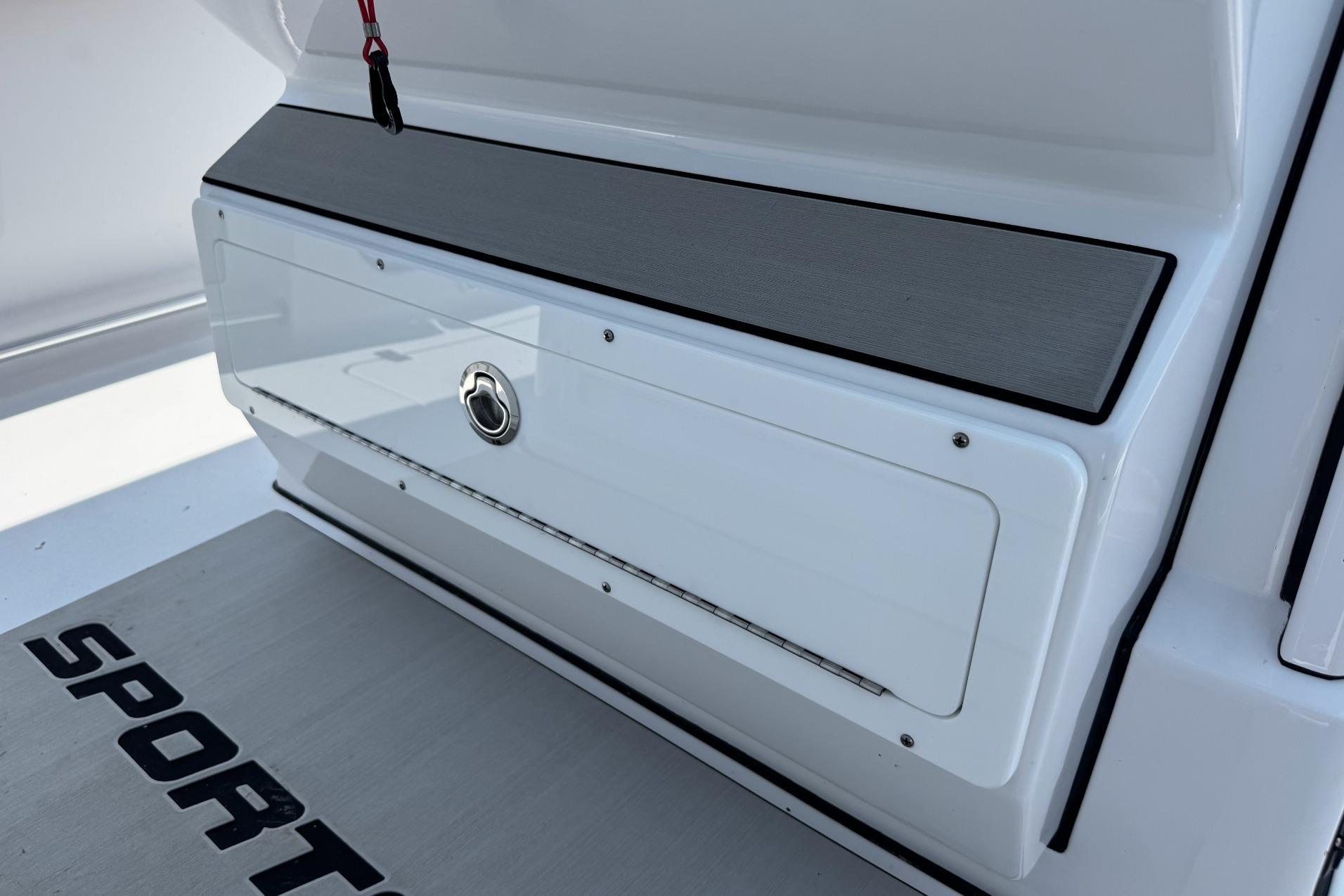 2026 Sportsman Open 262 Center Console boat storage compartment with sleek design and secure latch.