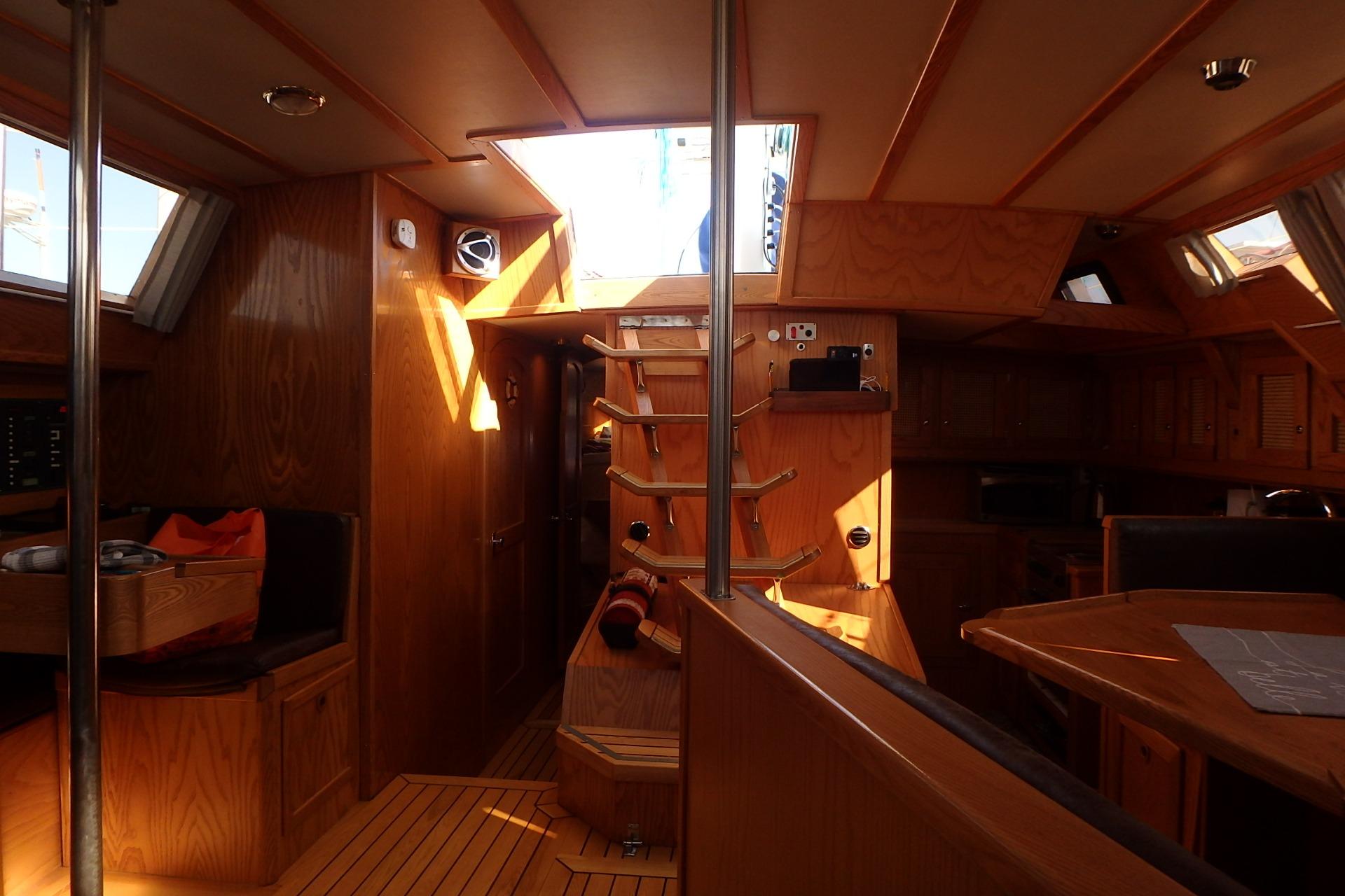 Interior of 2017 Custom Gilbert Caroff Lex Eterna 47 yacht with wooden finish and natural light.