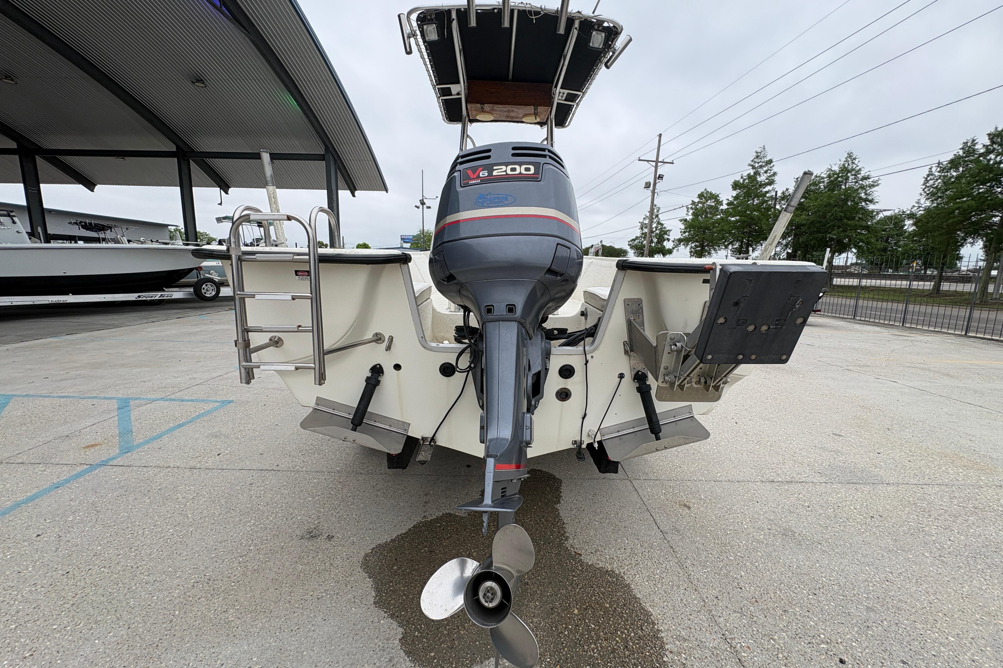 1998 Hydra-Sports 22 Ocean CC boat with V6 200 engine, rear view in parking lot.