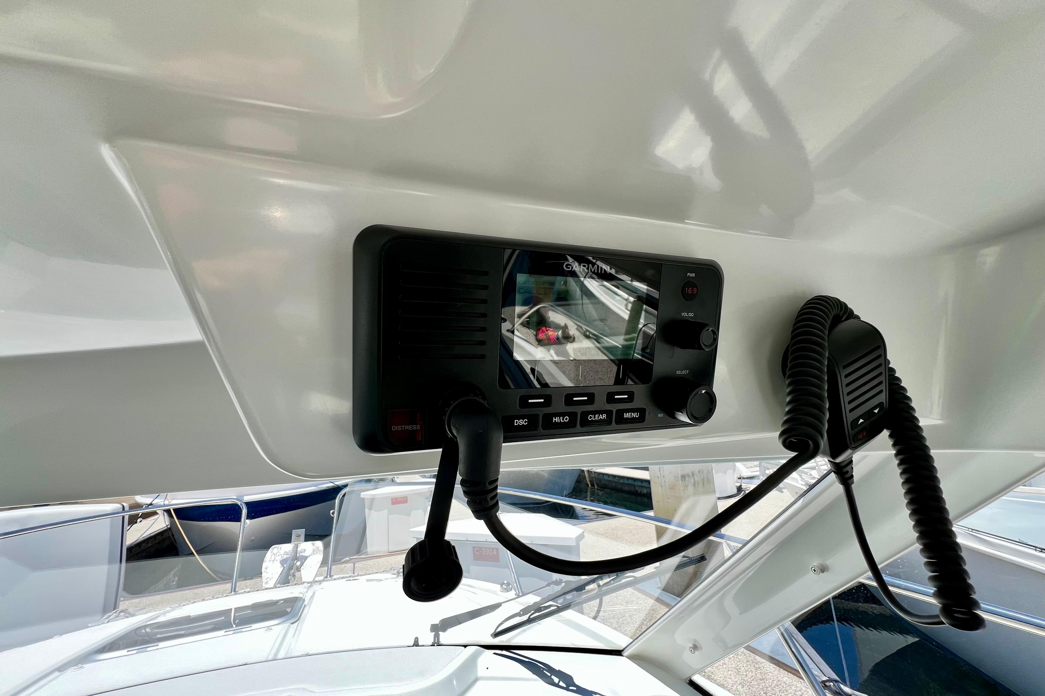 2023 Beneteau Antares 8 boat dashboard with Garmin marine radio and microphone.