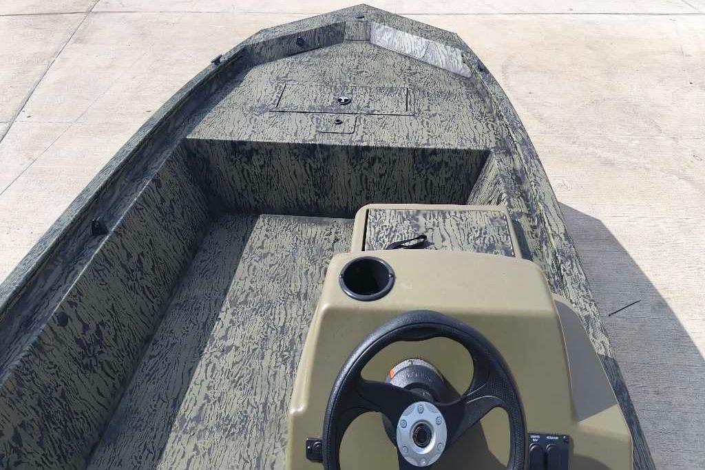 2026 Tracker Grizzly 1648 SC boat interior with camouflage design and steering console.