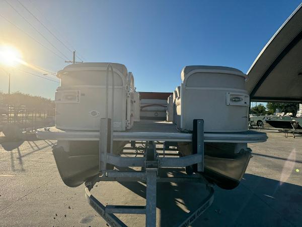 2005 Starcraft 22 Sport pontoon boat on trailer under clear blue sky.