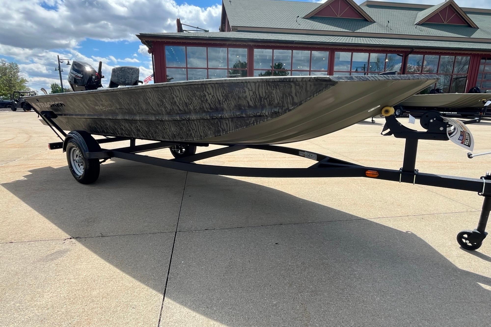 2026 Tracker Grizzly 1654 T Sportsman boat on trailer, outdoors under a cloudy sky.
