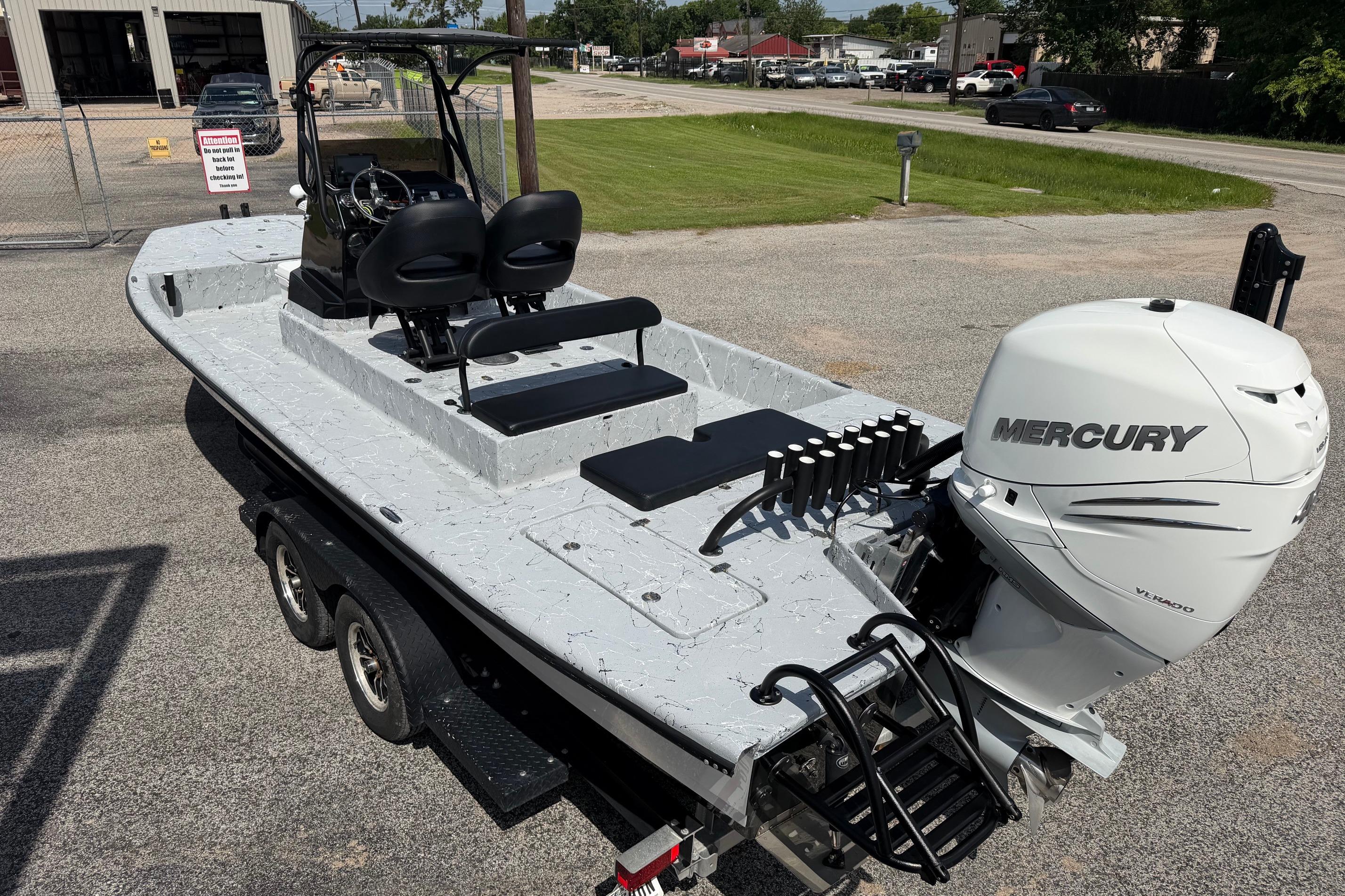 2023 Haynie 23 Super Cat boat with Mercury engine on trailer in parking lot.