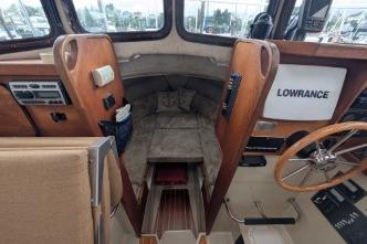 2008 Ranger 25 cabin interior with steering wheel and navigation equipment.