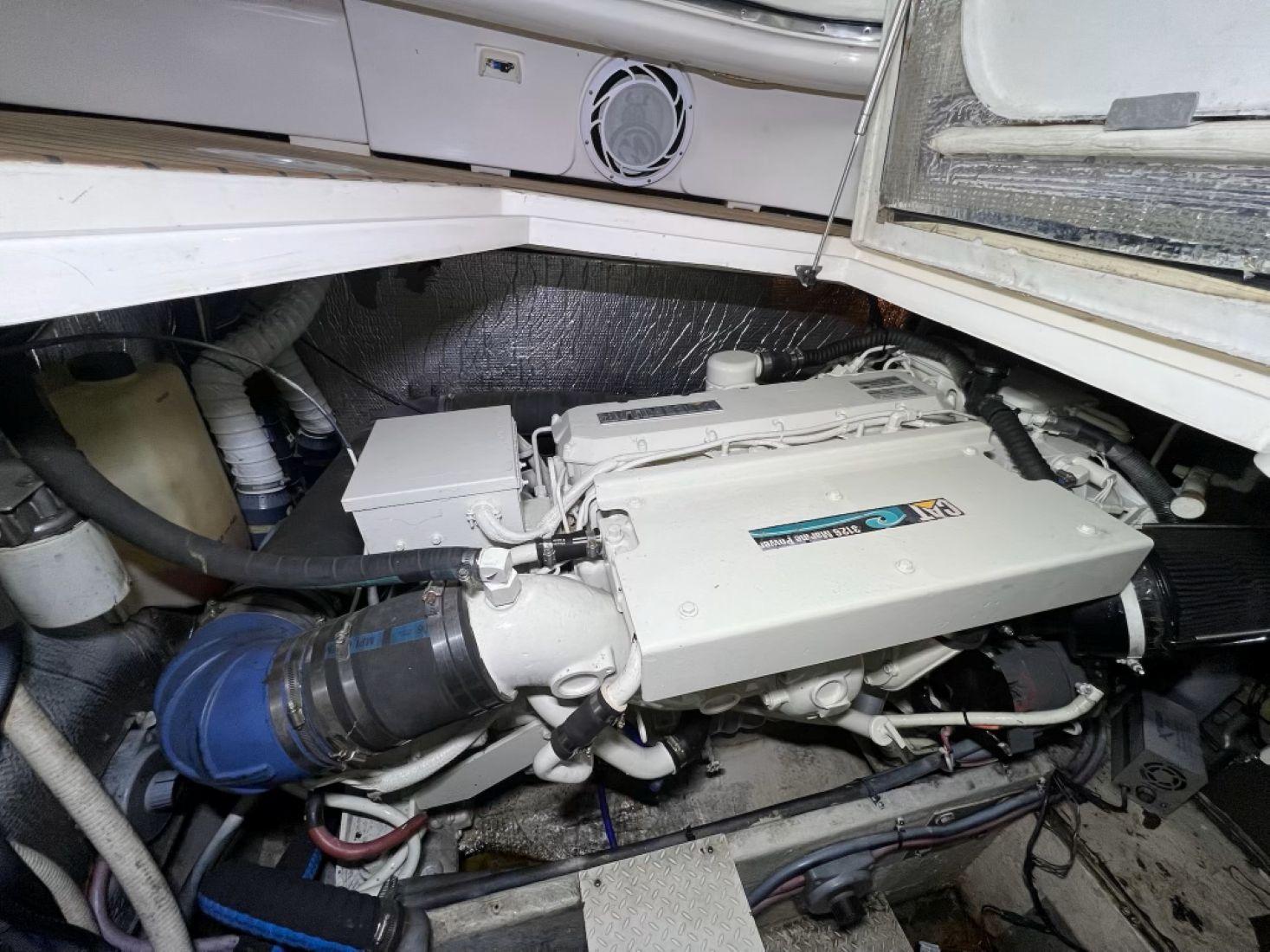 Engine room of 2000 Cruisers Yachts 4270 Express, showcasing marine engine components.