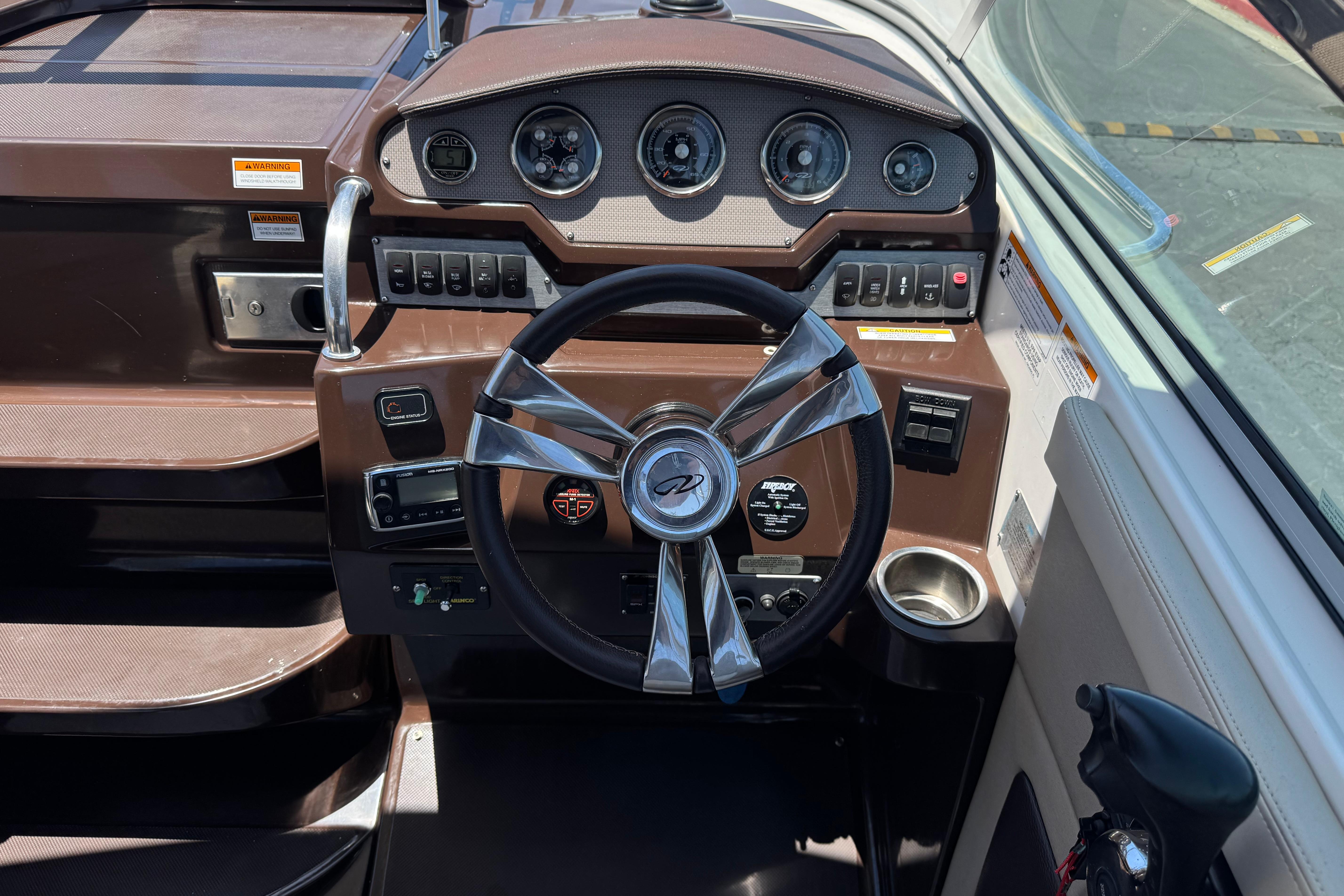 Dashboard of a 2013 Regal 28 Express boat with steering wheel and controls.