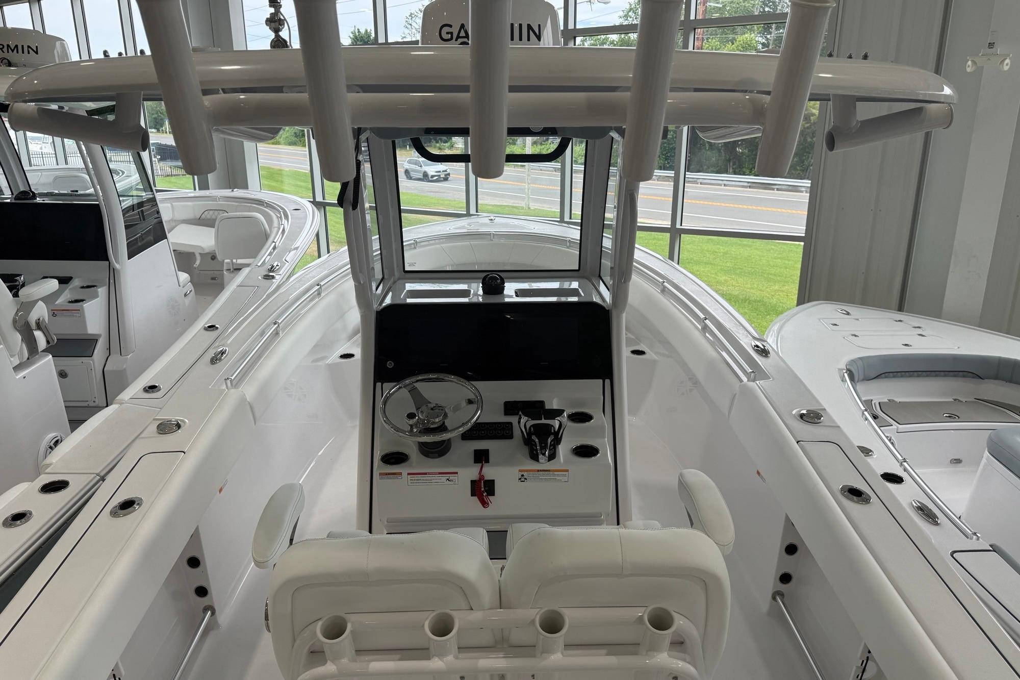 2026 Sportsman Open 252 Center Console boat interior with steering wheel and seating.