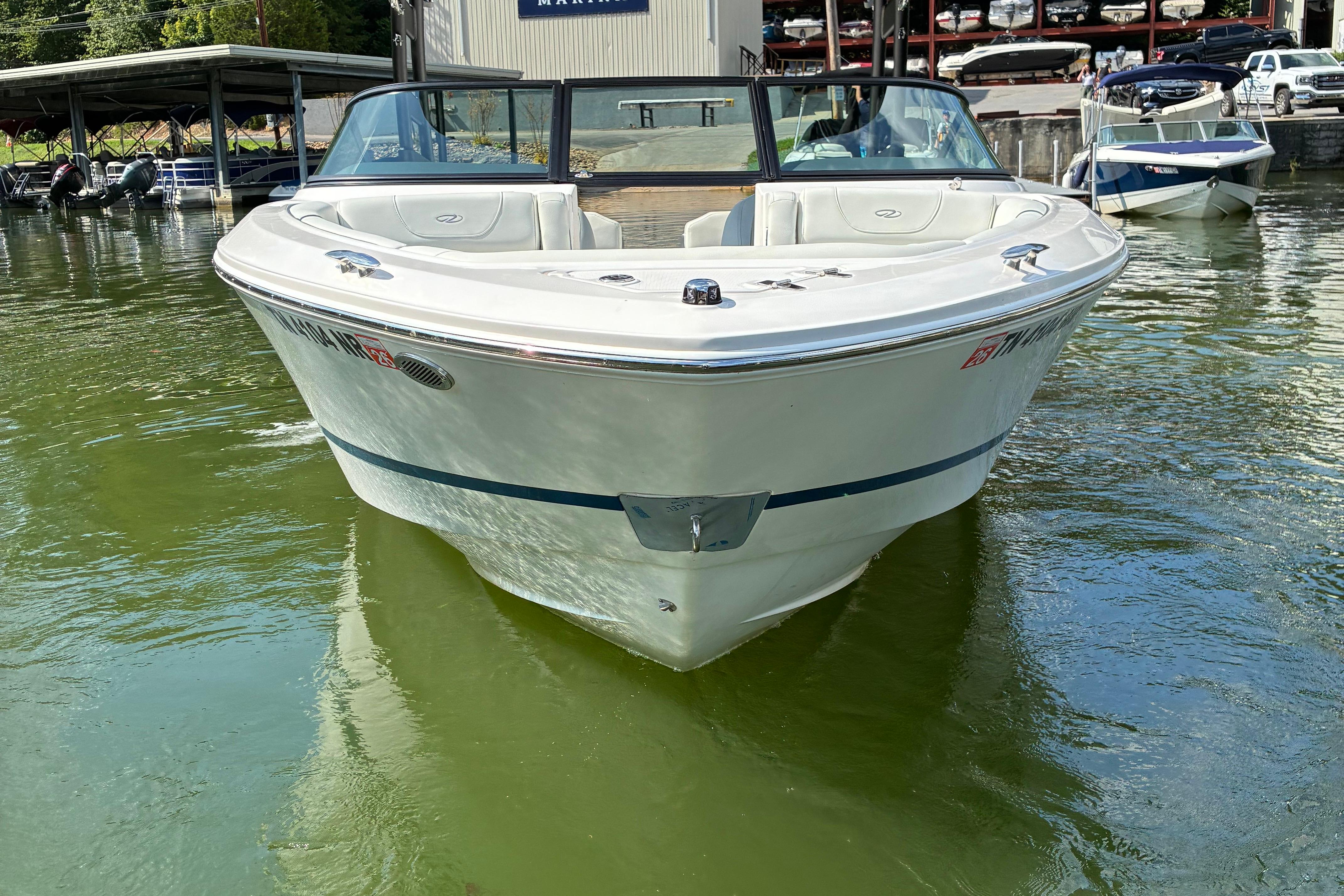 2025 Regal LS2 boat docked on calm water, showcasing sleek design and modern features.