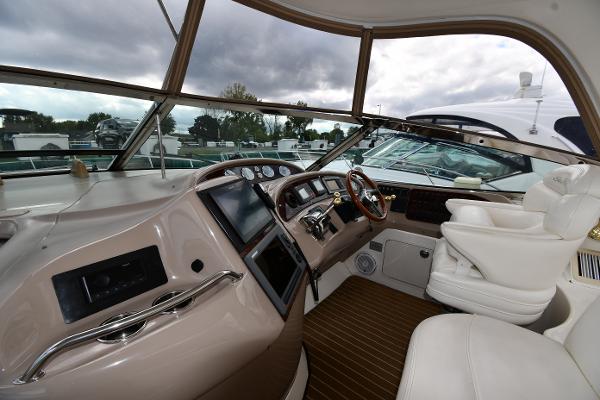 Interior cockpit of 2003 Sea Ray 460 Sundancer yacht with modern controls and seating.
