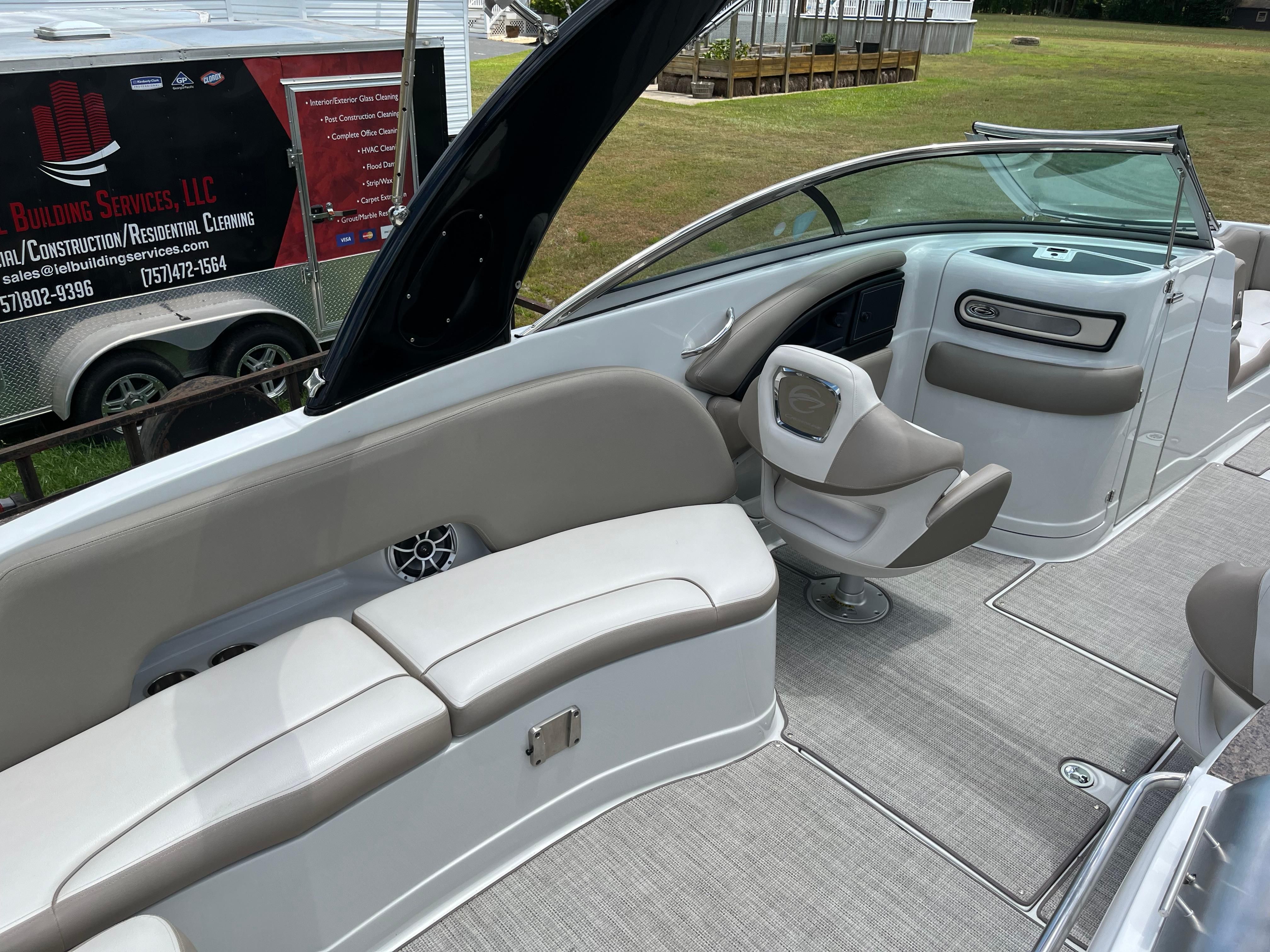 The image shows the cockpit of a 2019 Crownline E 285 boat with gray upholstery.