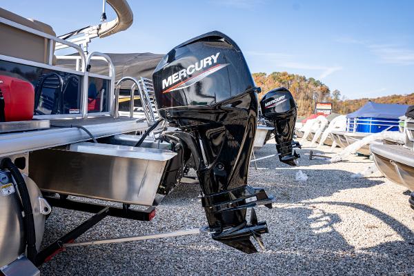 2025 Sun Tracker Bass Buggy 16 DLX with Mercury outboard motor in a marina setting.