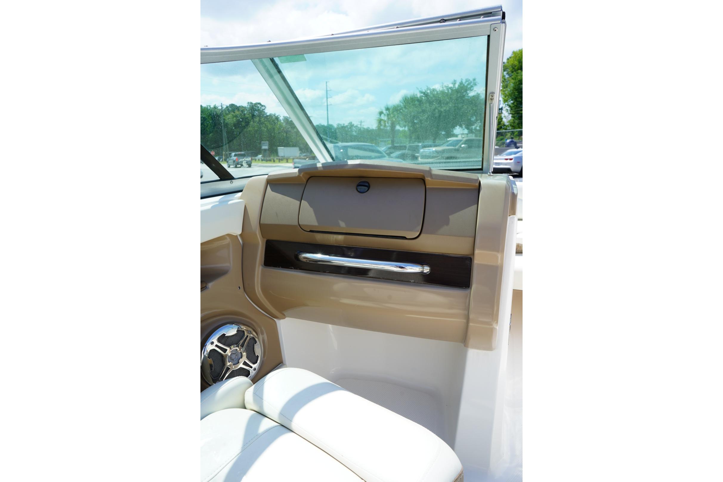 Interior view of 2013 Chaparral 206 SSi boat, featuring dashboard and seating.