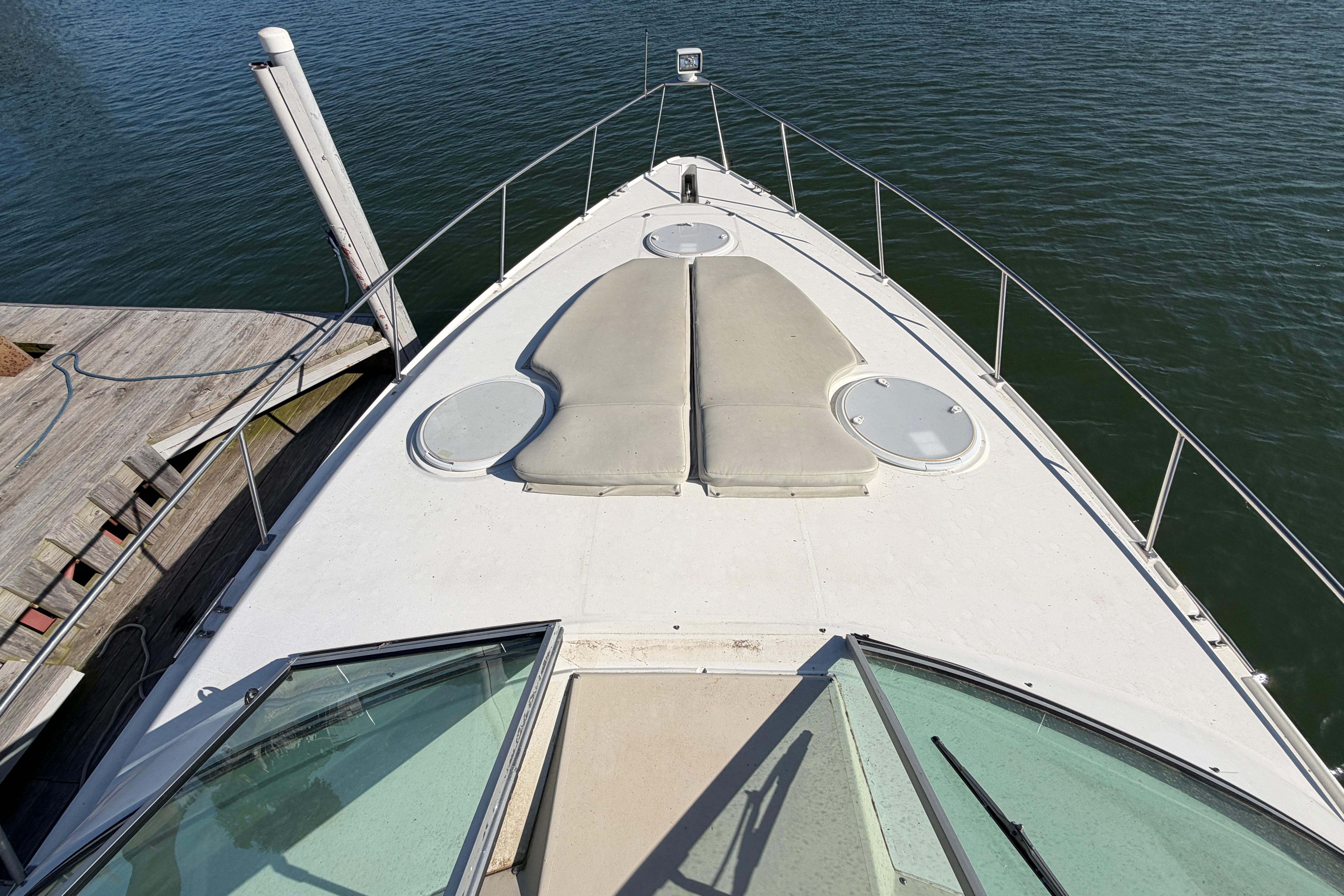 1997 Cruisers 3575 boat deck view, docked by the water.