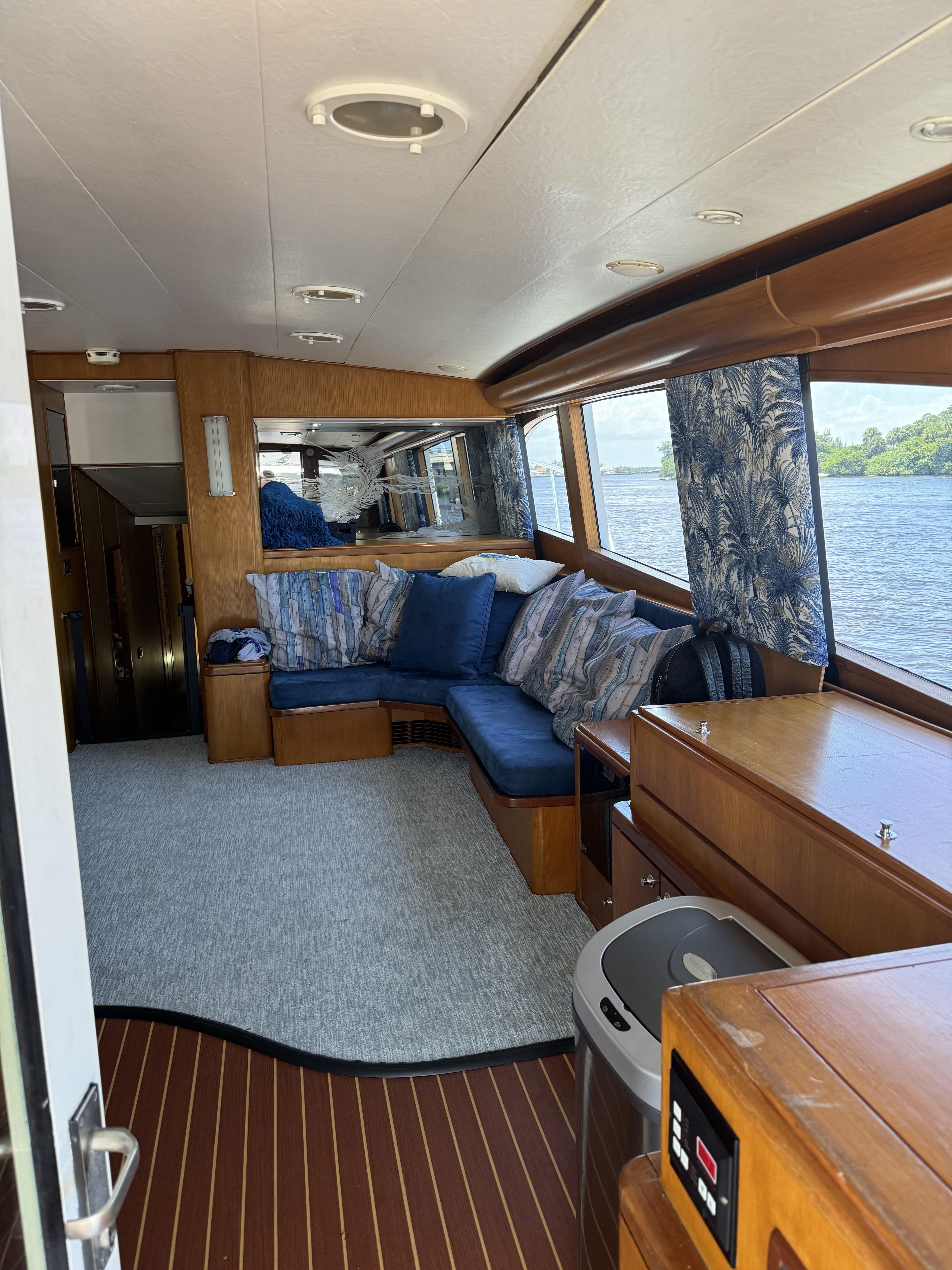 Luxurious interior of 1993 Palmer Johnson Sportfish yacht with plush seating and scenic water views.