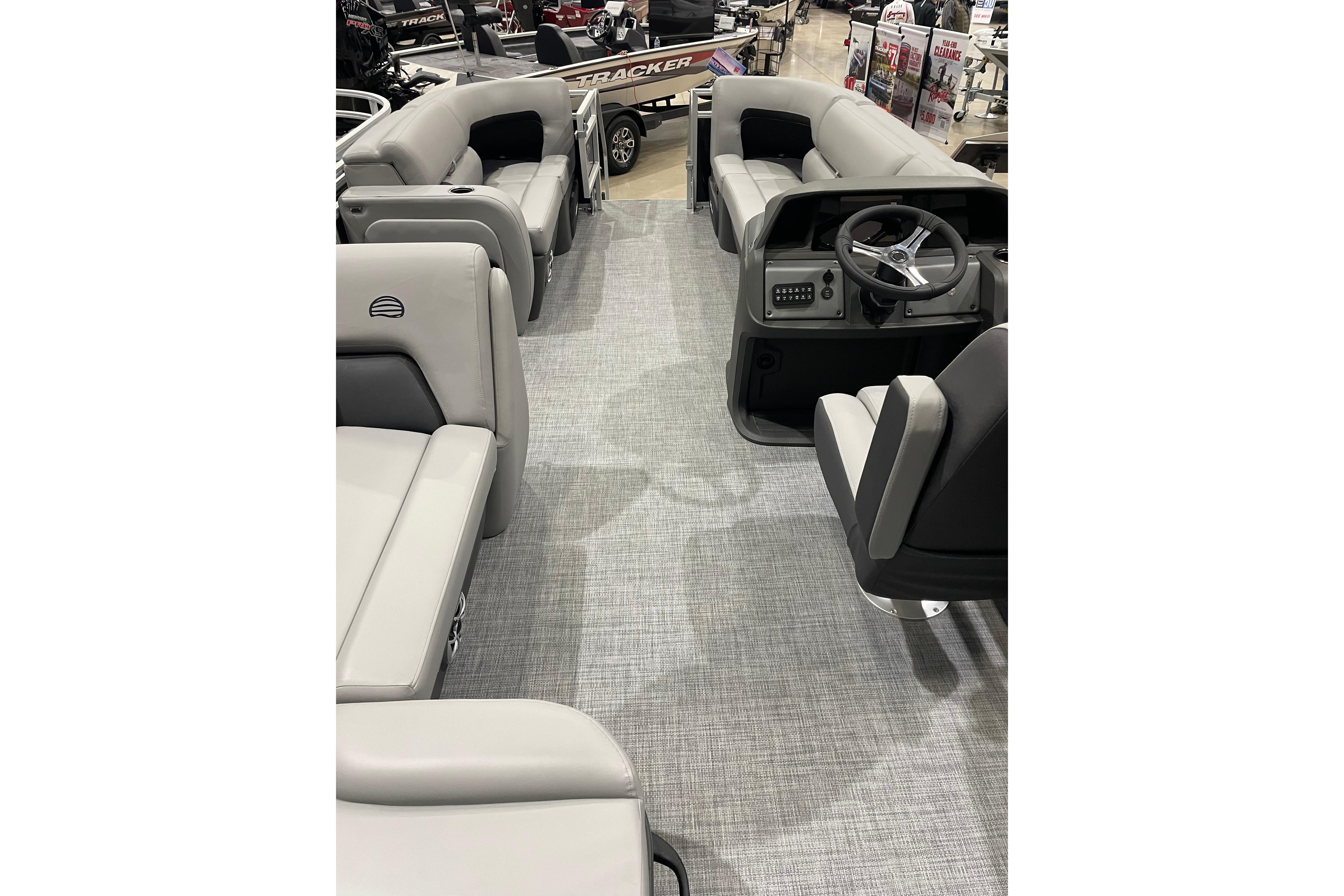 2026 Sun Tracker SportFish 22 DLX interior with gray seating and steering console.