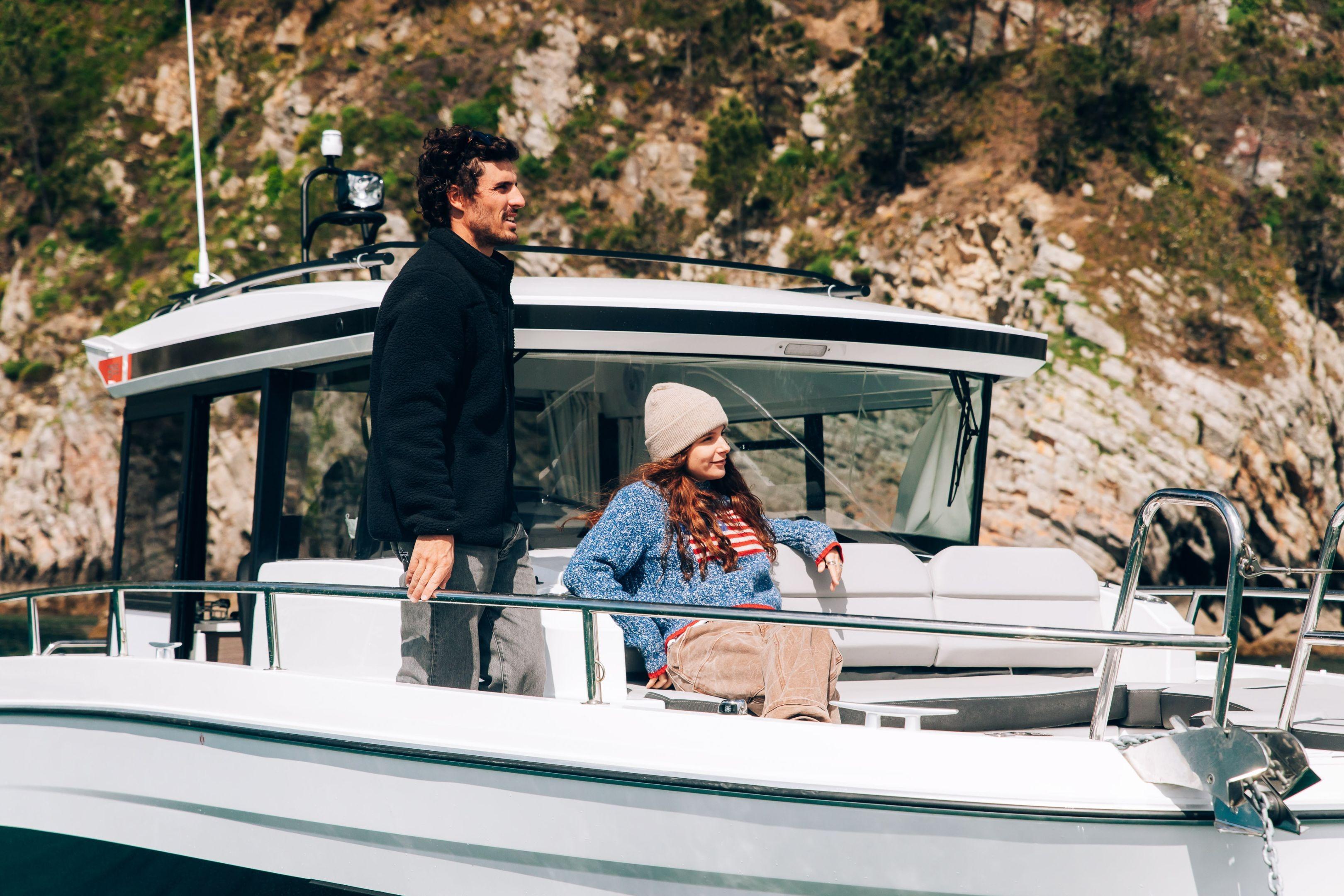 2026 Jeanneau NC 895 Sport Series 2 with two people enjoying a scenic boat ride.