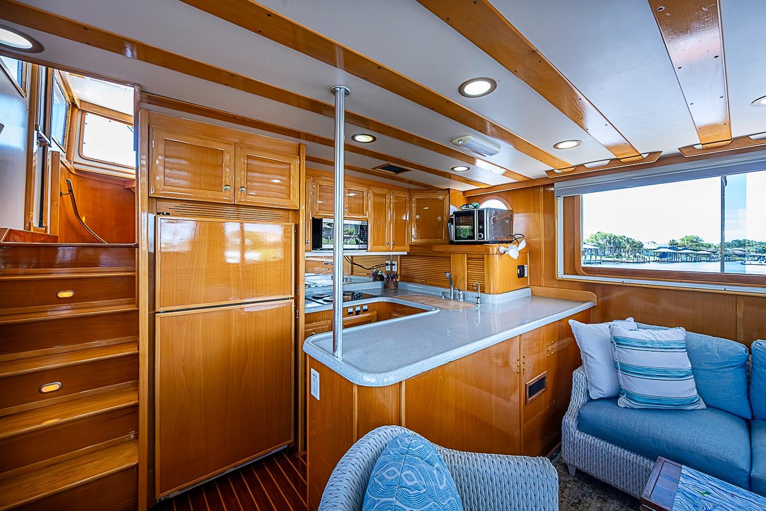 Luxurious 2003 Magna Marine Nova Scotia 47 yacht interior with wooden cabinetry and modern amenities.
