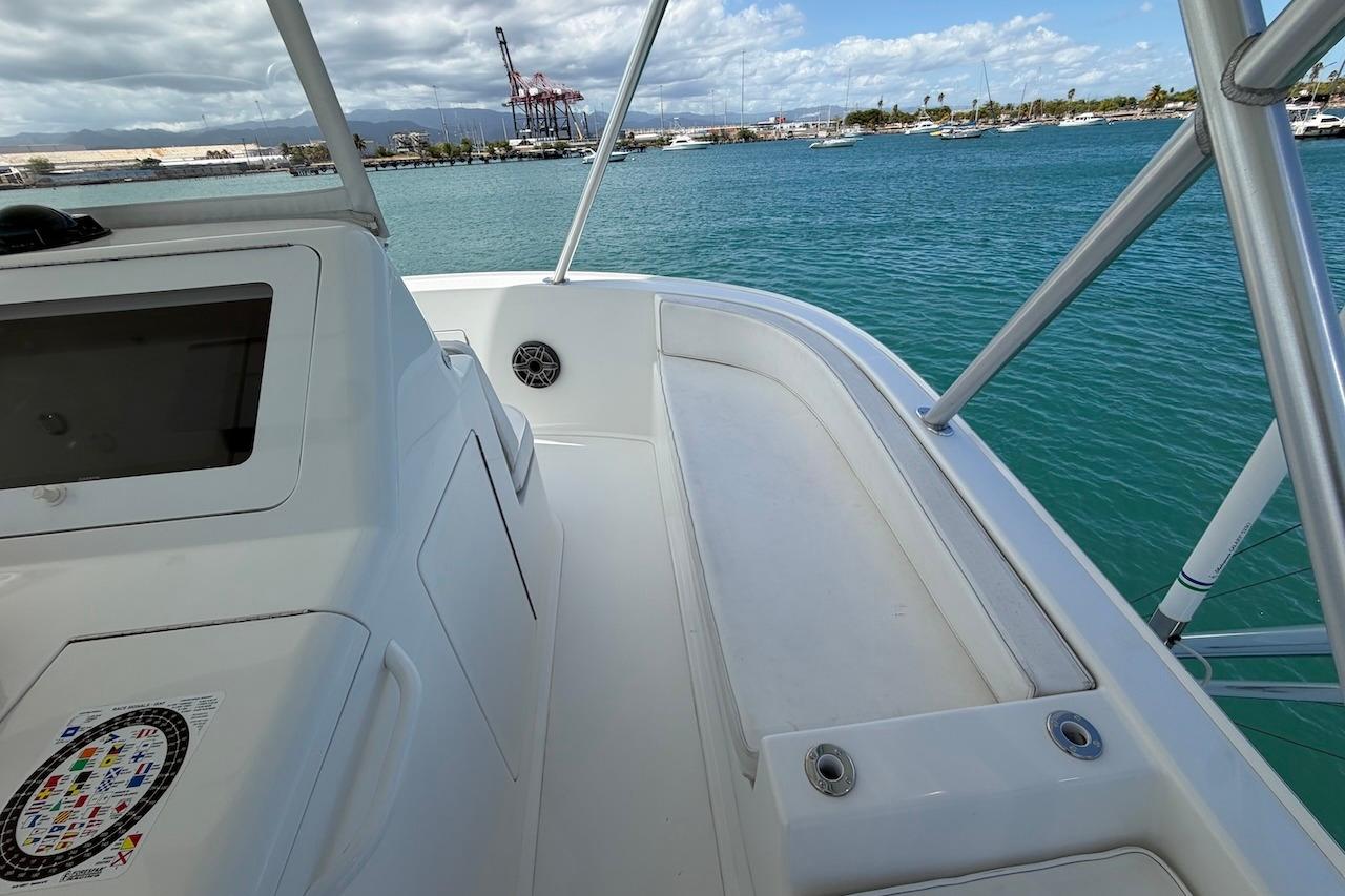 2012 Viking 50 Convertible yacht deck with ocean view and marina backdrop.