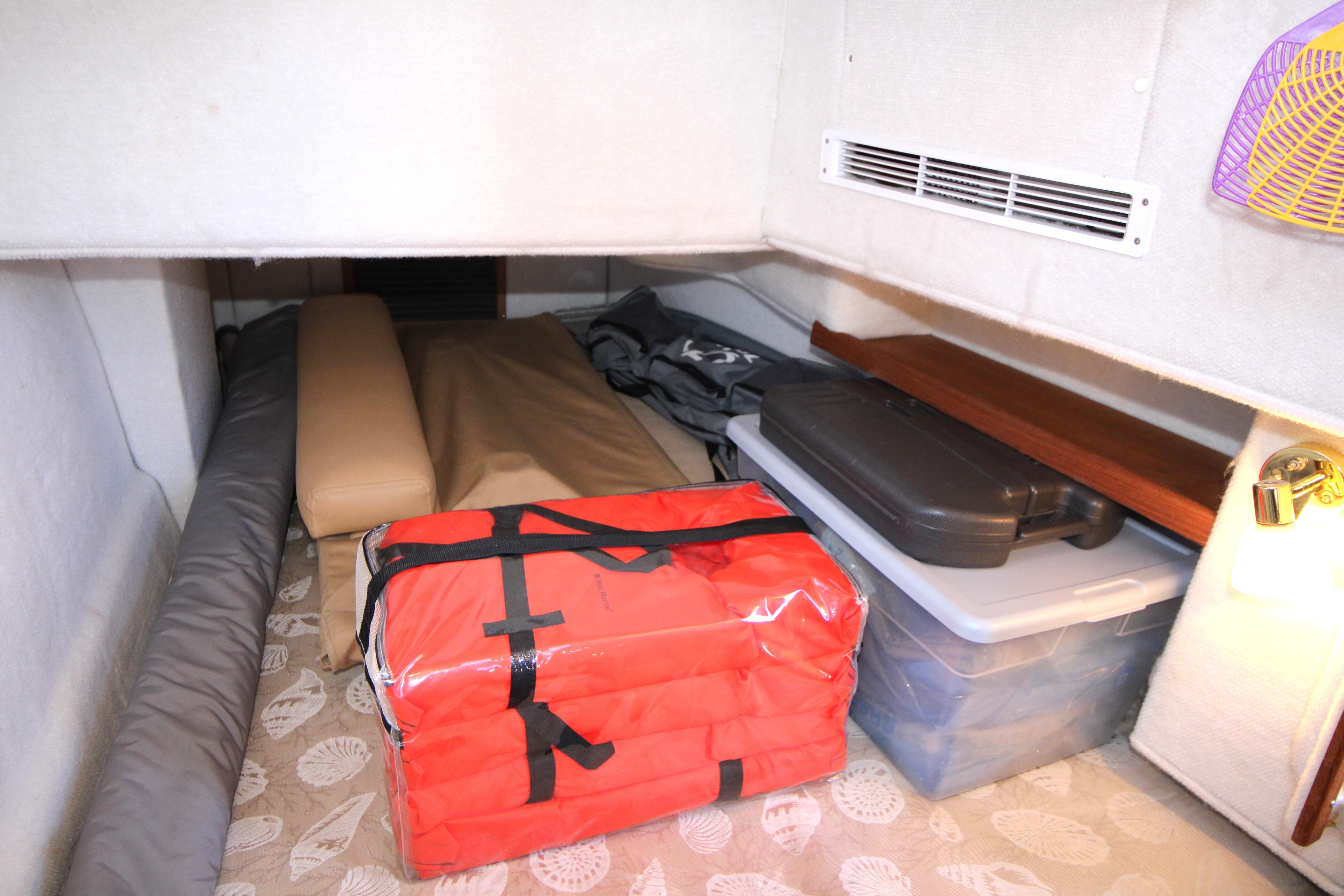 Storage area in 2013 Ranger Tugs R-31 CB with life jackets and containers.
