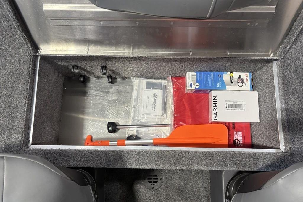 Storage compartment in 2026 Tracker Bass Tracker Classic XL boat with equipment and accessories.
