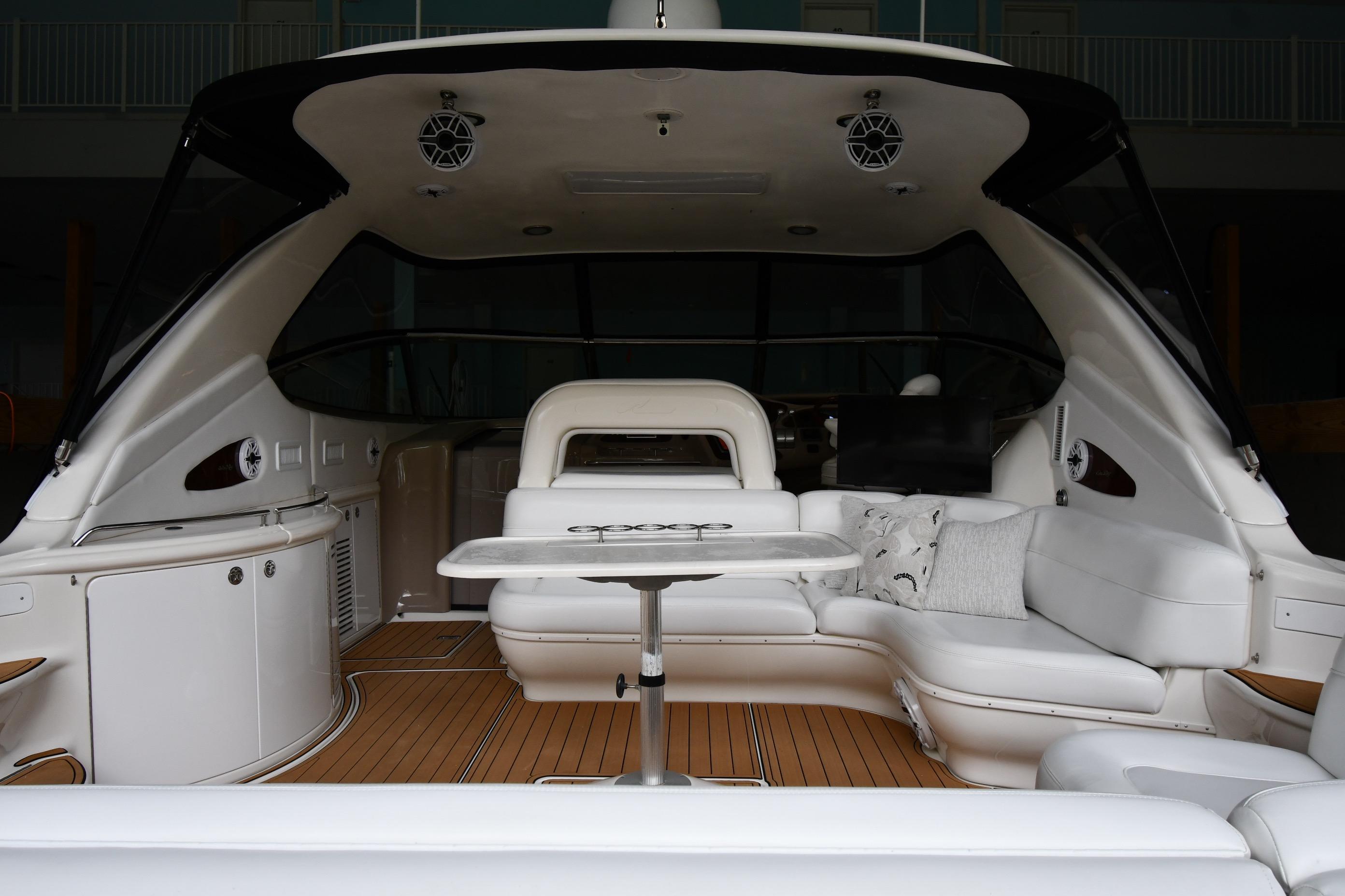2001 Sea Ray 540 Sundancer yacht interior with white seating and wooden flooring.