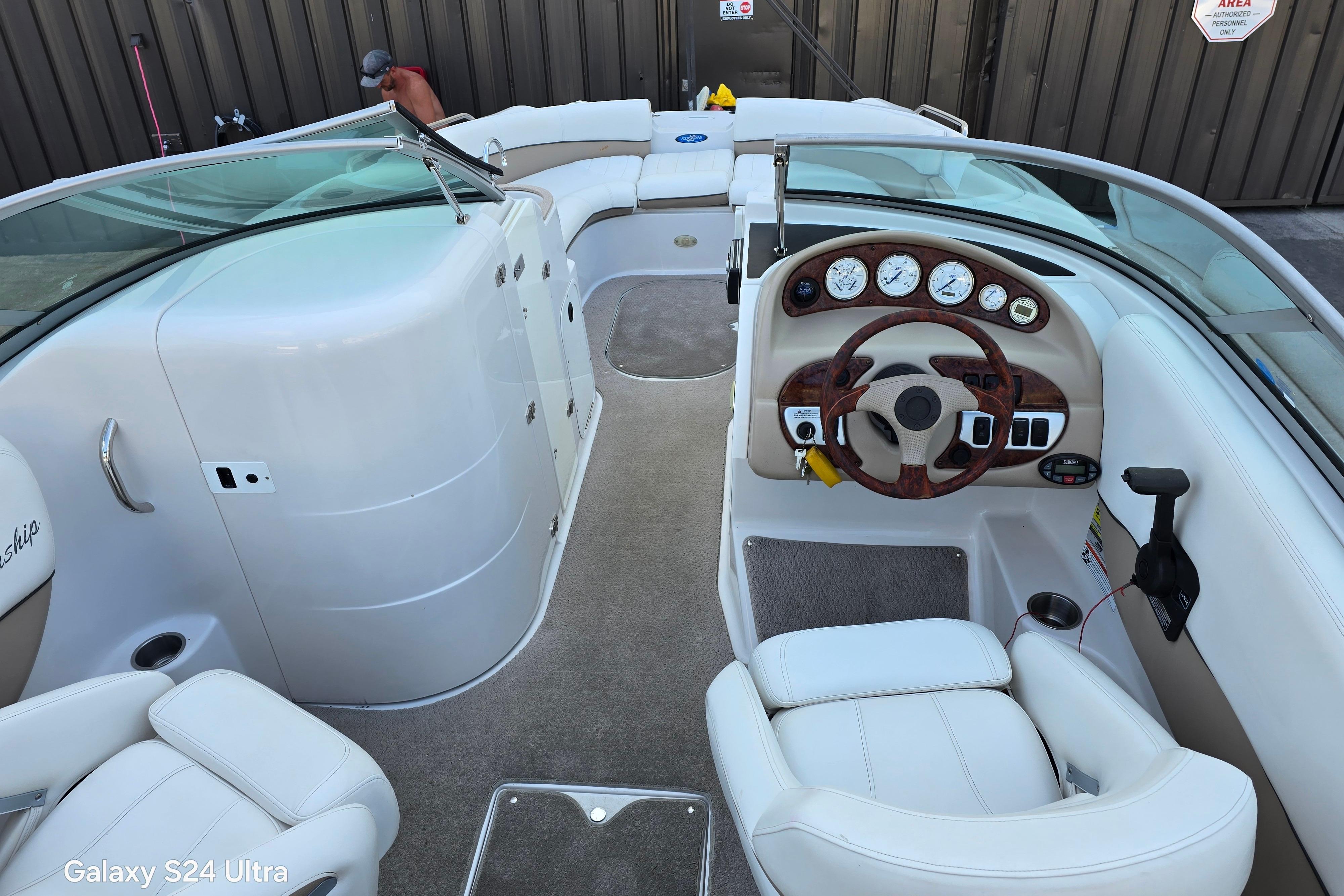 2006 Four Winns 244 Funship boat interior with steering wheel and seating.