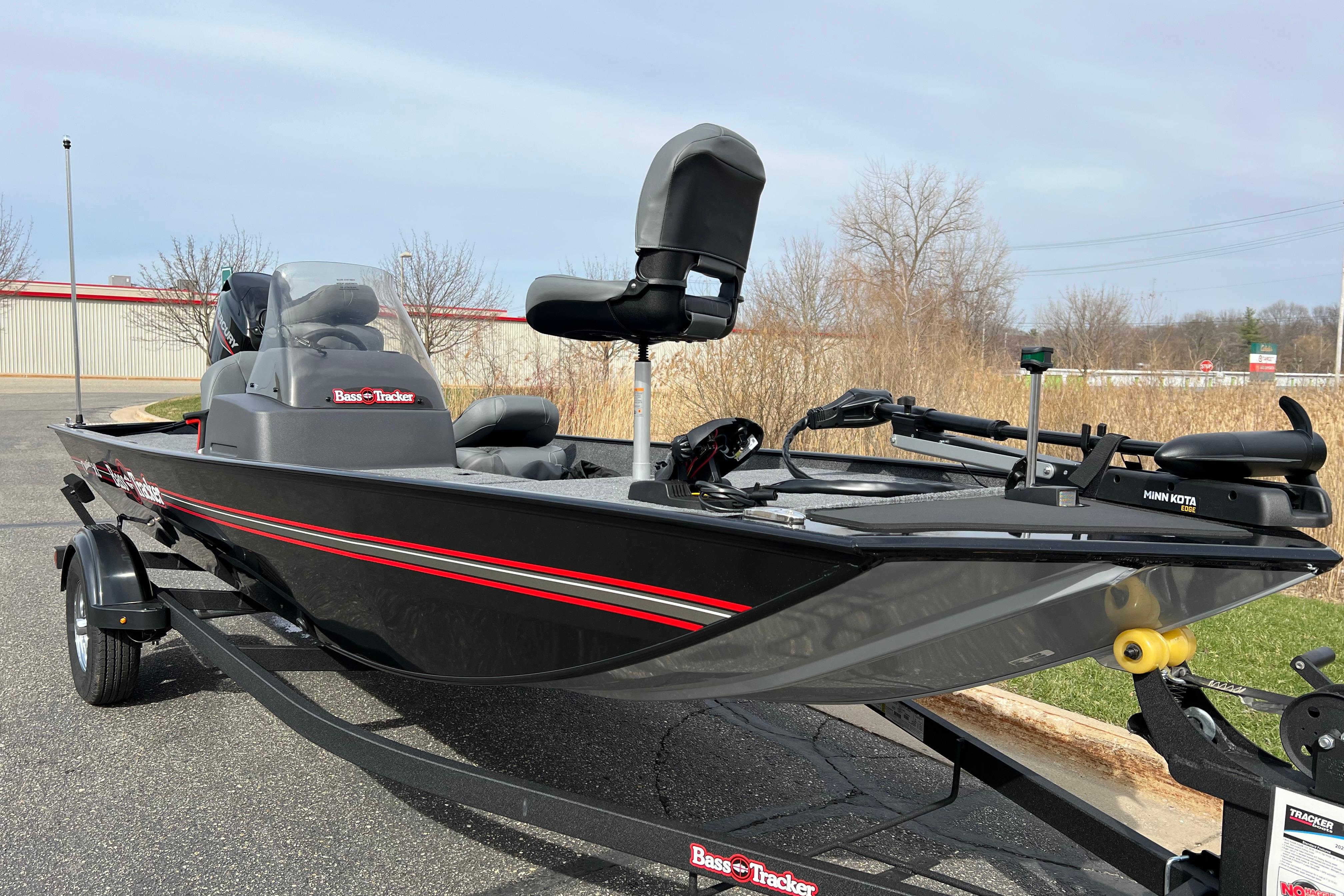 2026 Tracker Bass Tracker Classic XL fishing boat on trailer, featuring sleek black design.