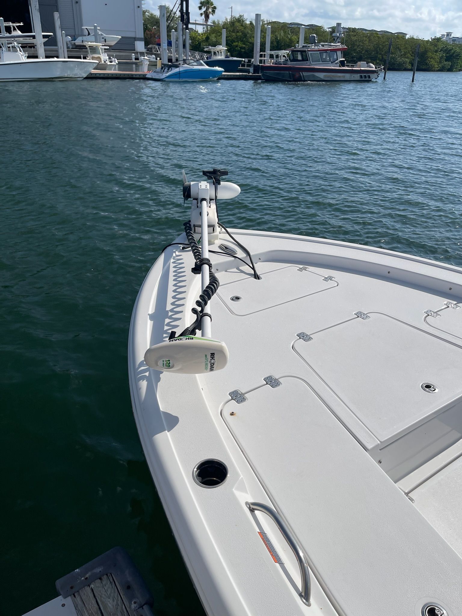 The image shows the bow of a 2022 Sportsman Masters 247 Bay Boat docked in a marina.